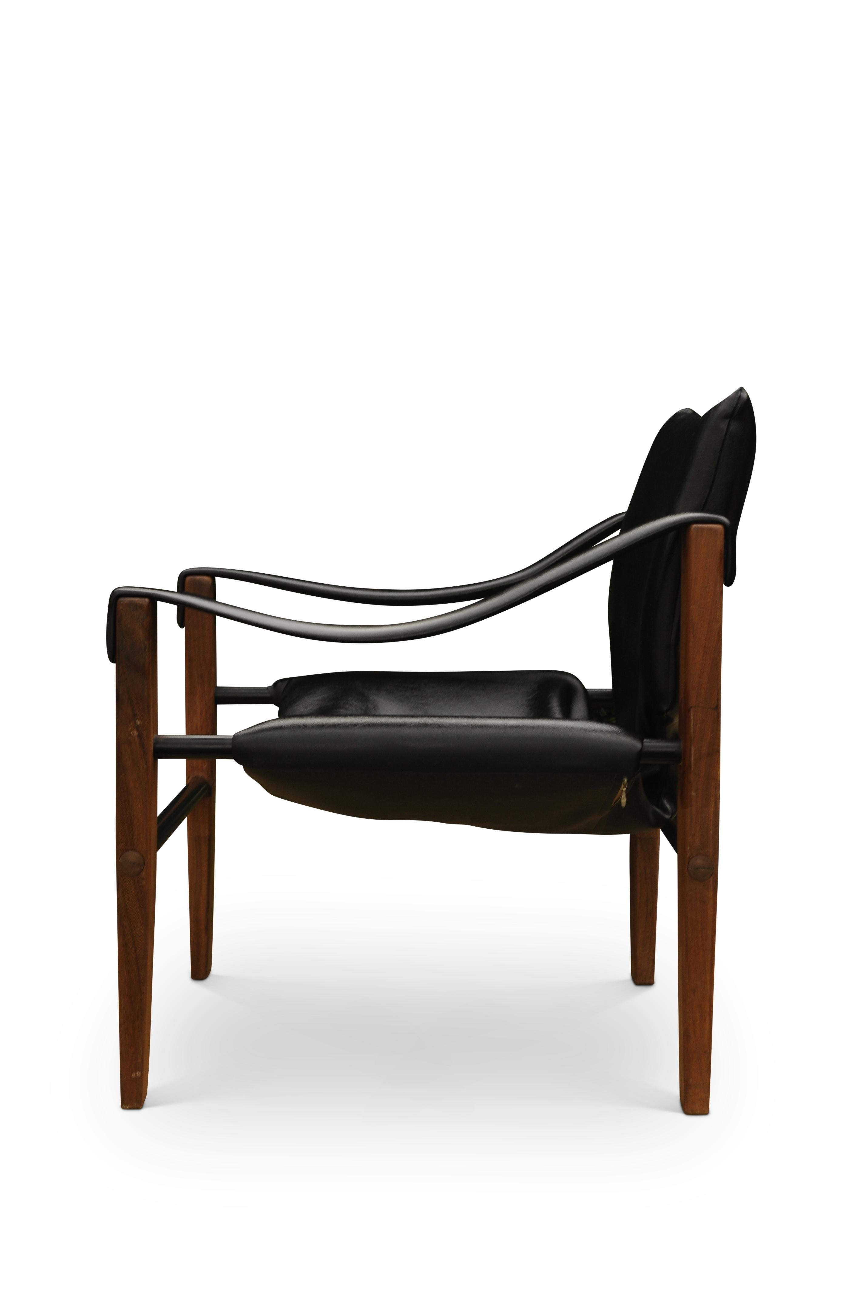 An original arkana black and teak safari chair by Maurice Burke. Based on the original designs by the British Empire for Military Campaign Safari chairs, followed by the Scandinavian designs of the mid-century.