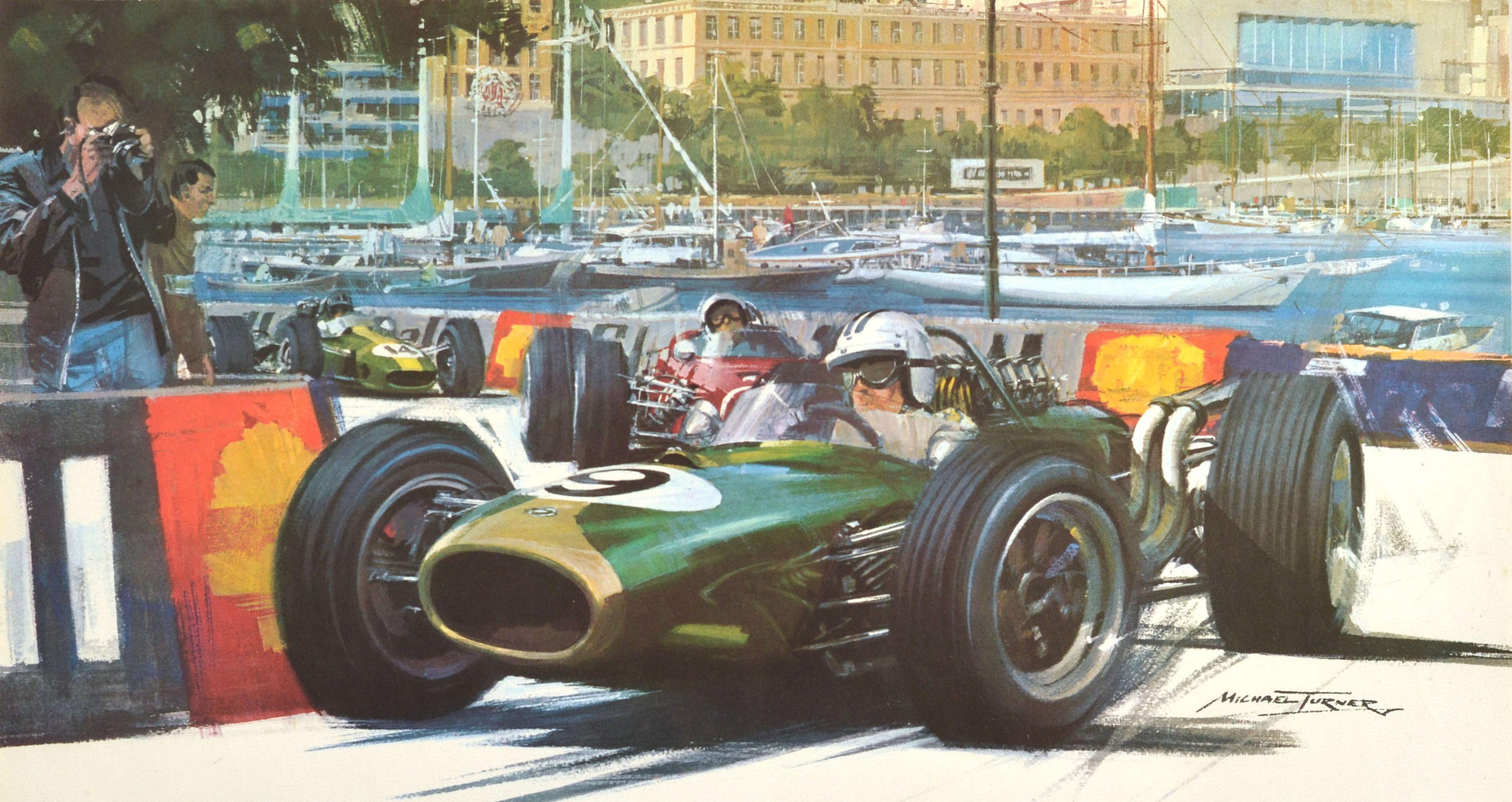 Original vintage F1 motor sport poster for the Monaco Grand Prix 1968 on 25/26 May featuring a dynamic design depicting a green number 9 racing car leading the GP race speeding by Shell advertising boards with a photographer catching the action on