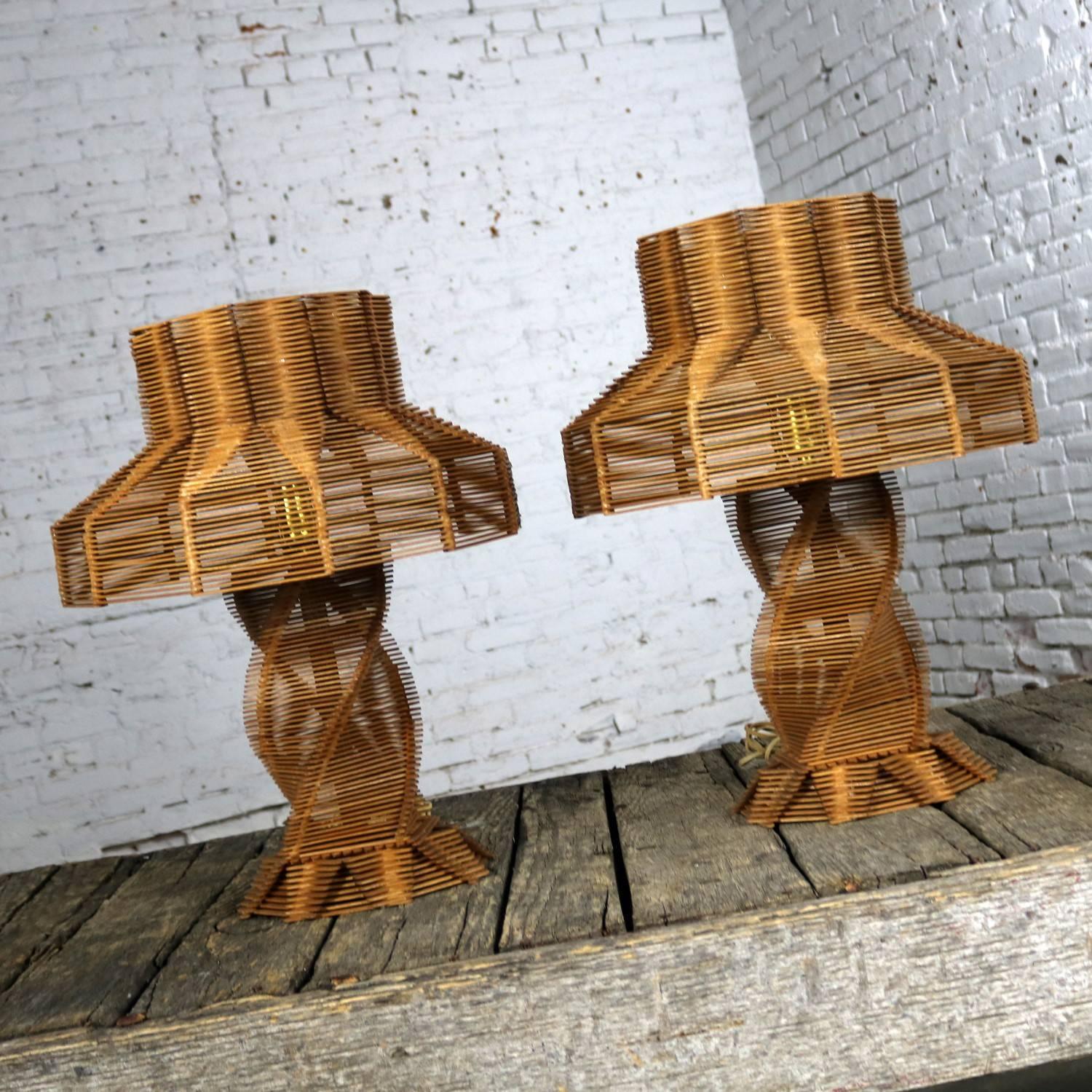 Incredible pair of Folk Art tramp art lamps made of popsicle sticks. They are in wonderful beautiful vintage condition with a patina that can only come with age. They have been rewired for today's standards. We believe these to be circa 1950s, but