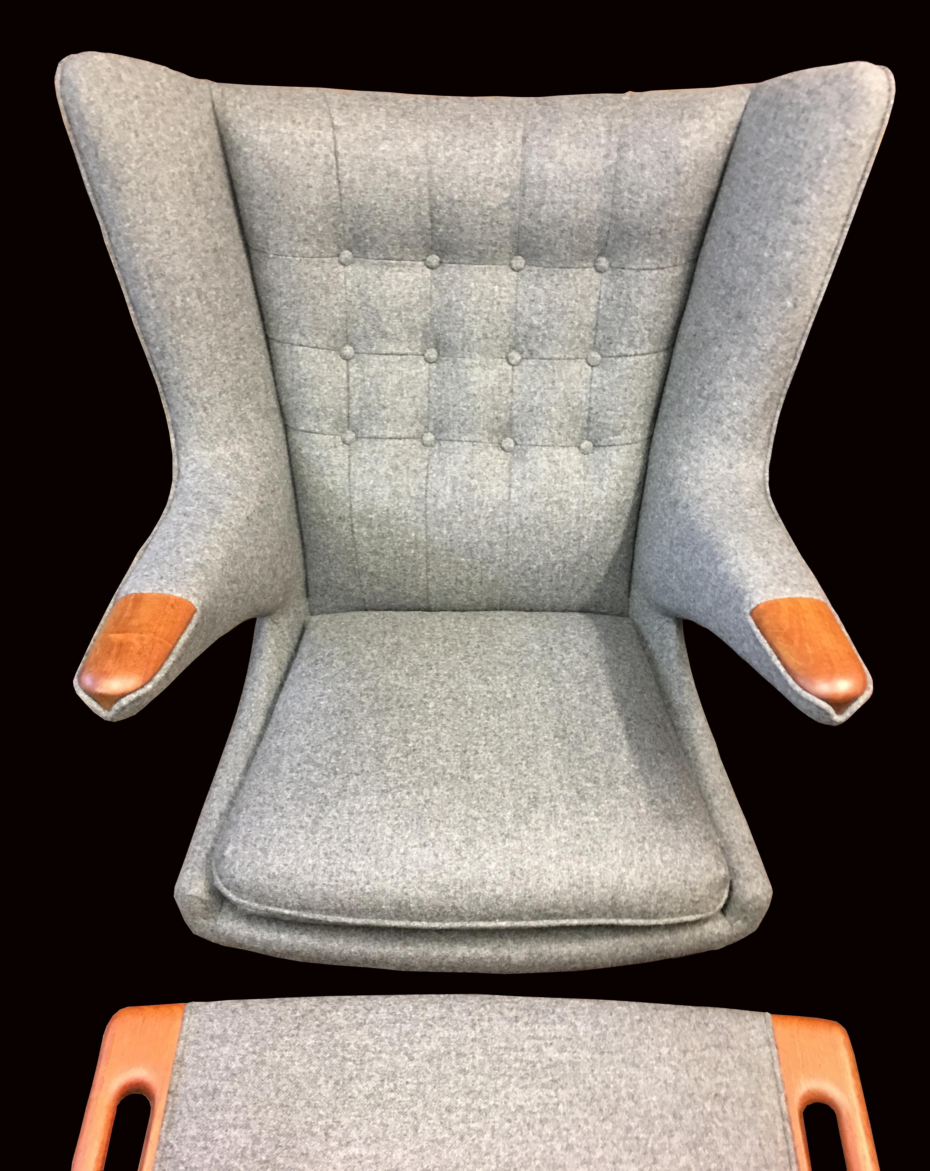 This is a particularly nice original example, produced some time in the 1960s, it has nicely patinated Teak legs and 'Paws' all in very good condition, we have had it completely reupholstered in high quality grey 100% wool fabric that complies to