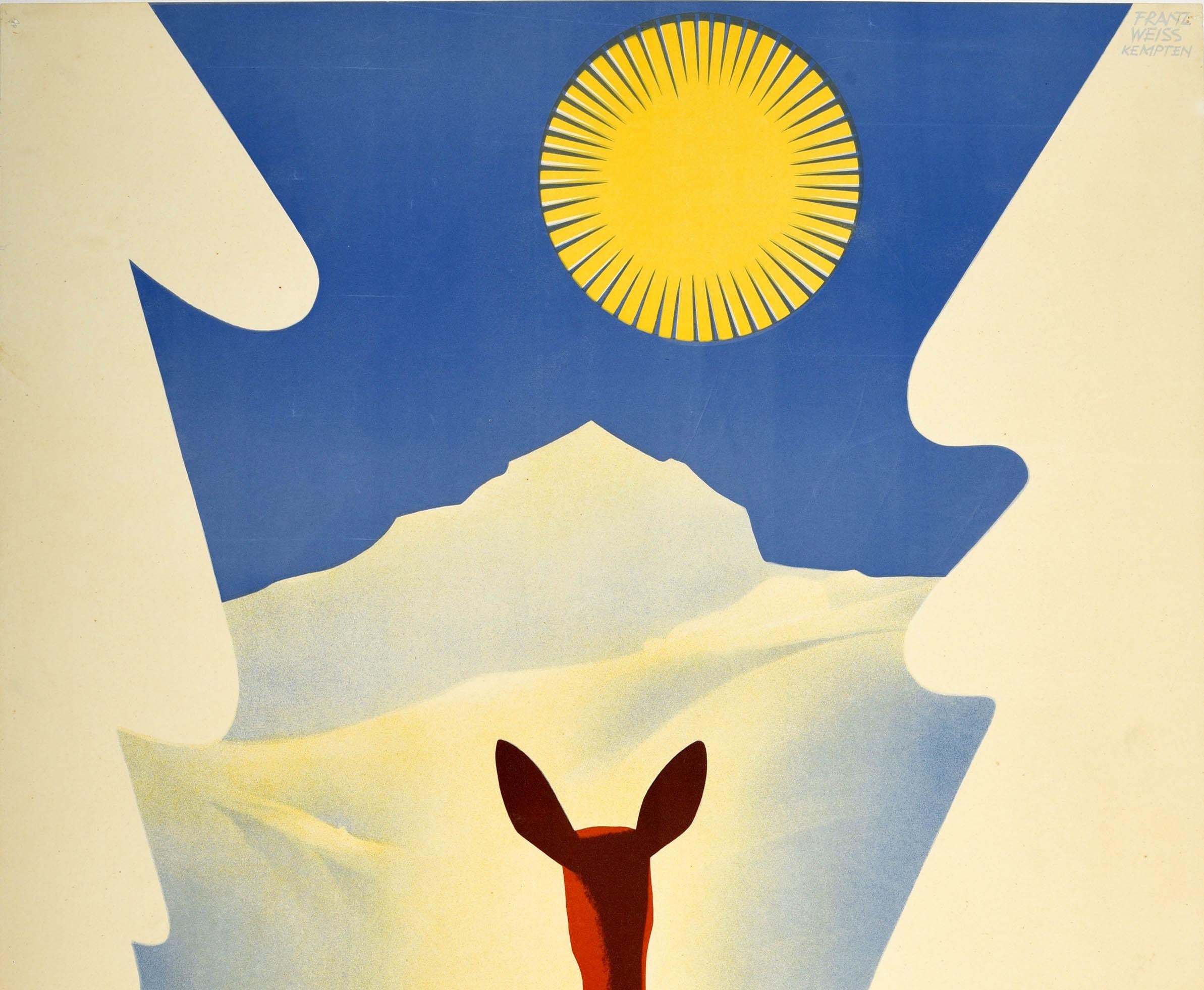 Original vintage winter travel poster for Allgau featuring stunning artwork by the painter and graphic designer Franz Weiss (1903-1981) featuring a deer standing between two snow white trees in the foreground with a skier skiing down a slope to a