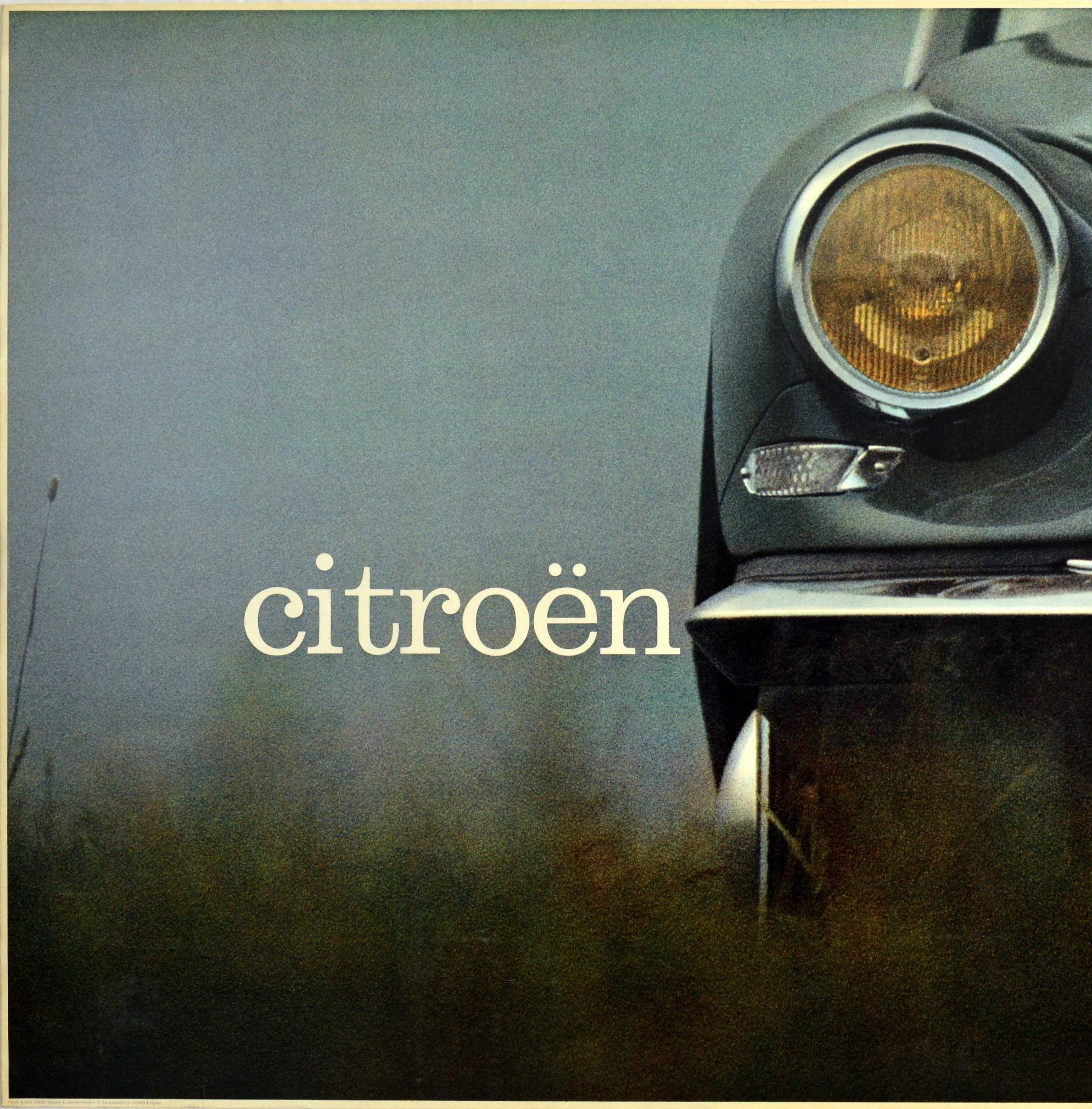 Original vintage car advertising poster issued by the French automobile manufacturer Citroen (founded 1919) featuring a great photograph of a 1960 Citroen DS showing a partial image of the front of the car with one yellow headlight and front grill