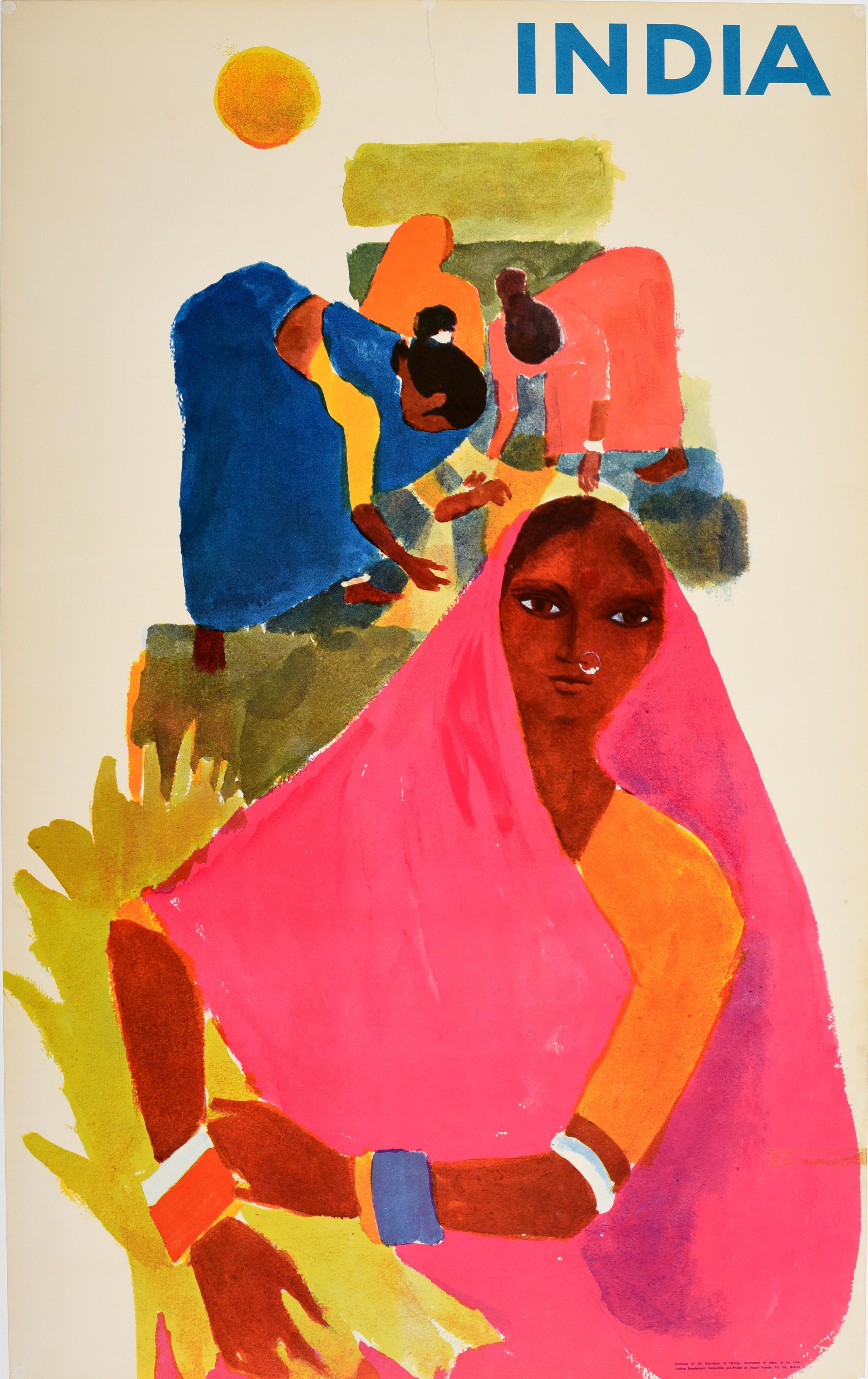 Original vintage travel poster for India featuring colourful artwork of people working on a field with a lady in the foreground and a sun in the sky next to the bold blue title text. Produced for the Department of Tourism Government of India and