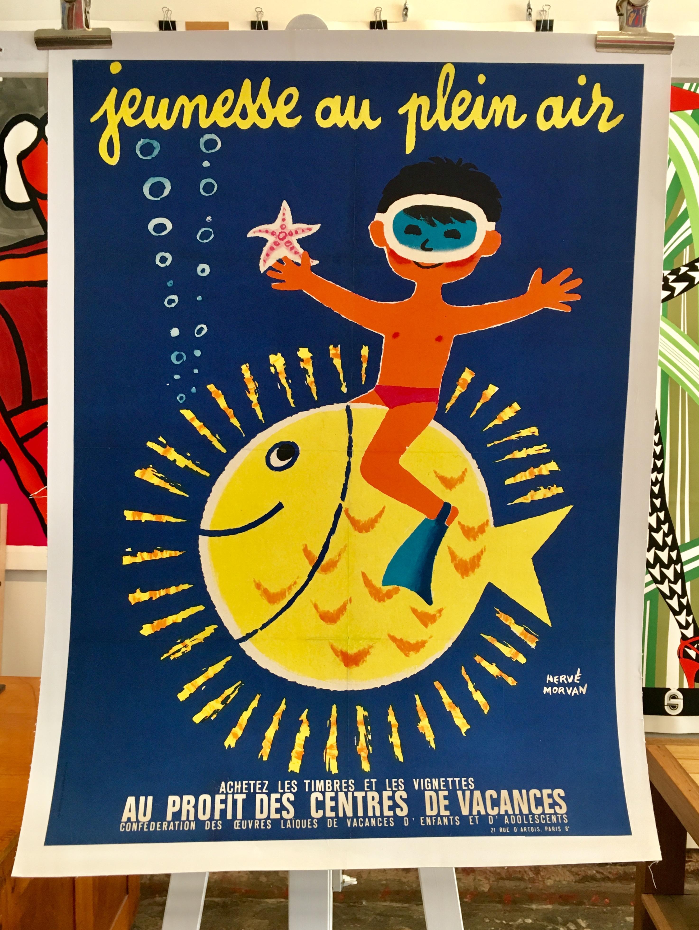 Original vintage poster Jeunesse Au Plein Air Boy with Fish by Herve Morvan 

Beautiful medium size poster by Herve Morvan advertising national summer camps for children in France, 'Jeunesse au plein air' translates to, 'Youth outdoors'. 

Herve