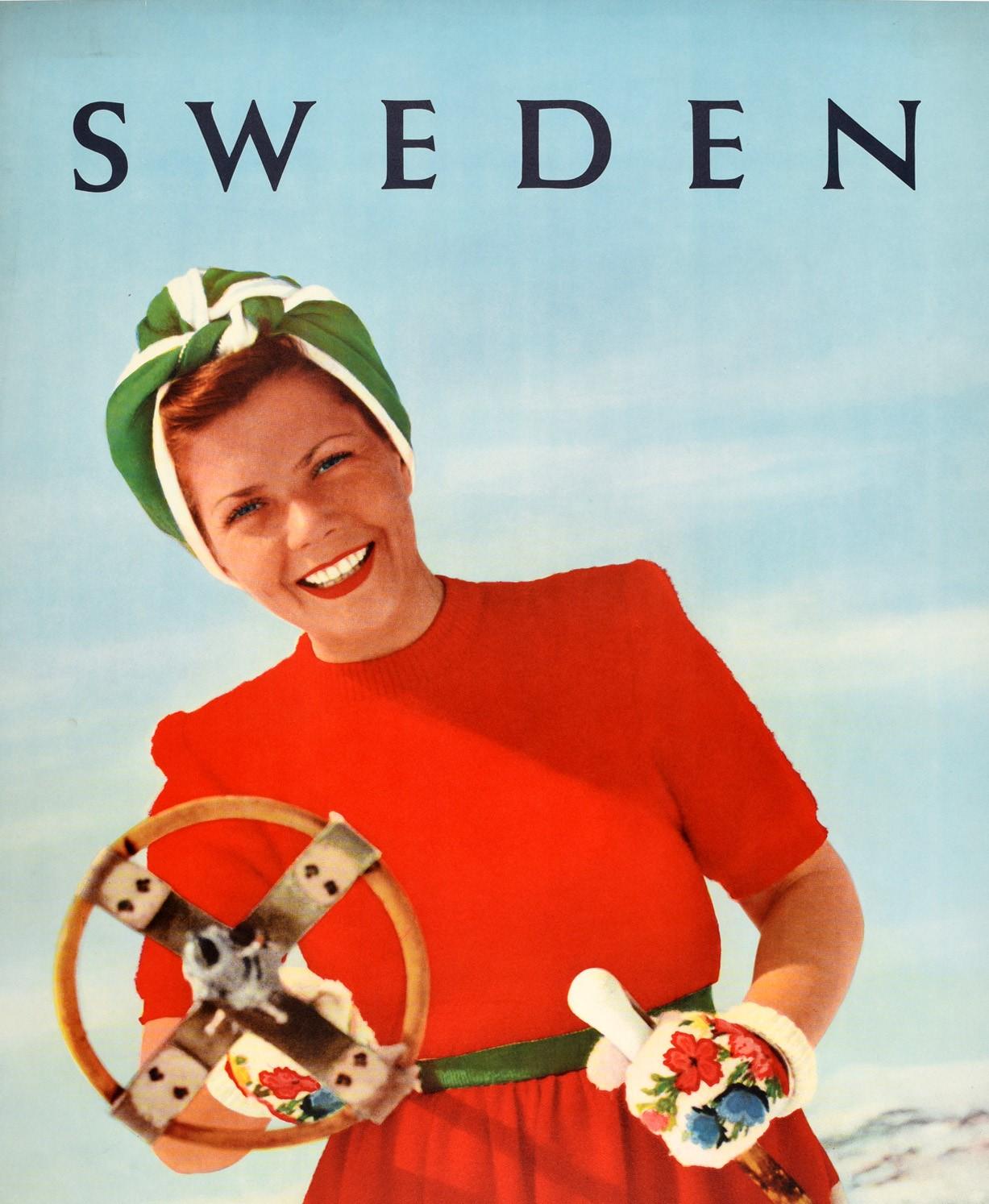 Original vintage ski travel poster for Sweden featuring a fun image of a smiling lady wearing a bright red, white and green dress with a head scarf and floral patterned gloves standing on a snowy mountain and pointing a wooden ski pole at the