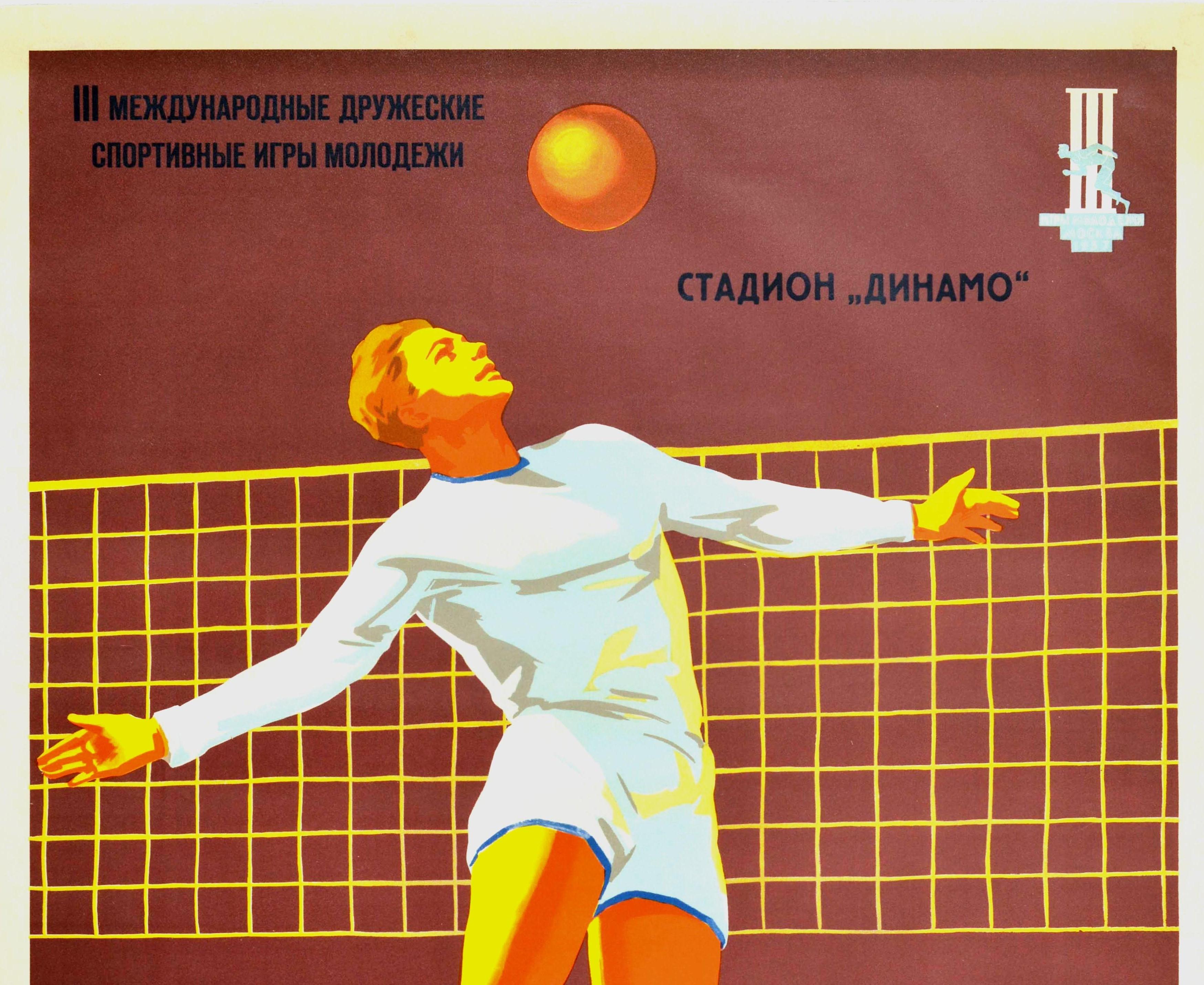 Original vintage sport poster for a volleyball competition at the III International Friendship Moscow Youth Games held from 30 July-9 August 1957 at the Dynamo Stadium featuring a volleyball player in white jumping up to hit the ball at the net in