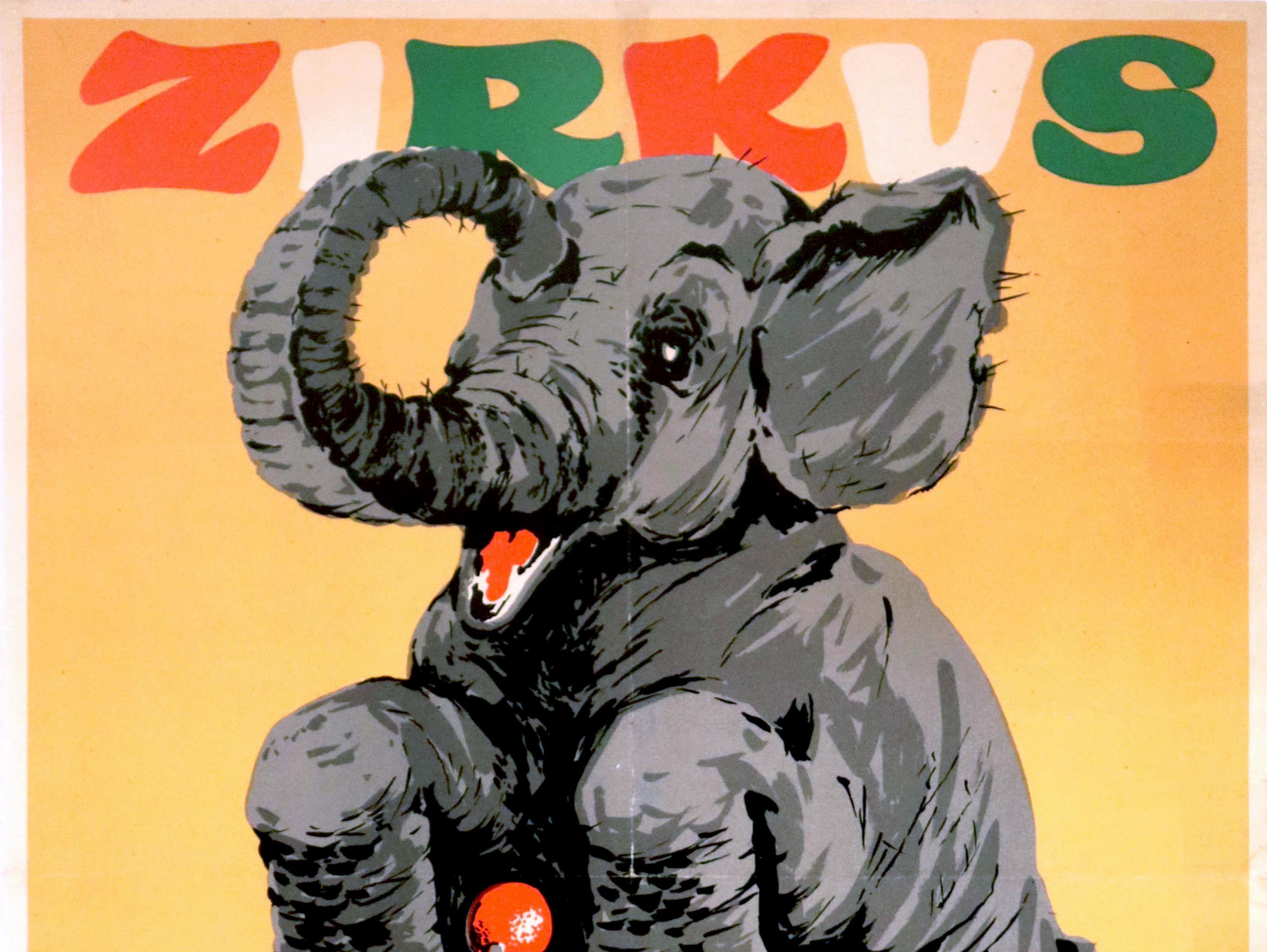 Original vintage advertising poster for a performance by Delhi the cycling elephant at the Zirkus Aeros circus featuring a fun colourful illustration of a grey elephant riding a red tricycle with the bold orange, white and green stylised lettering