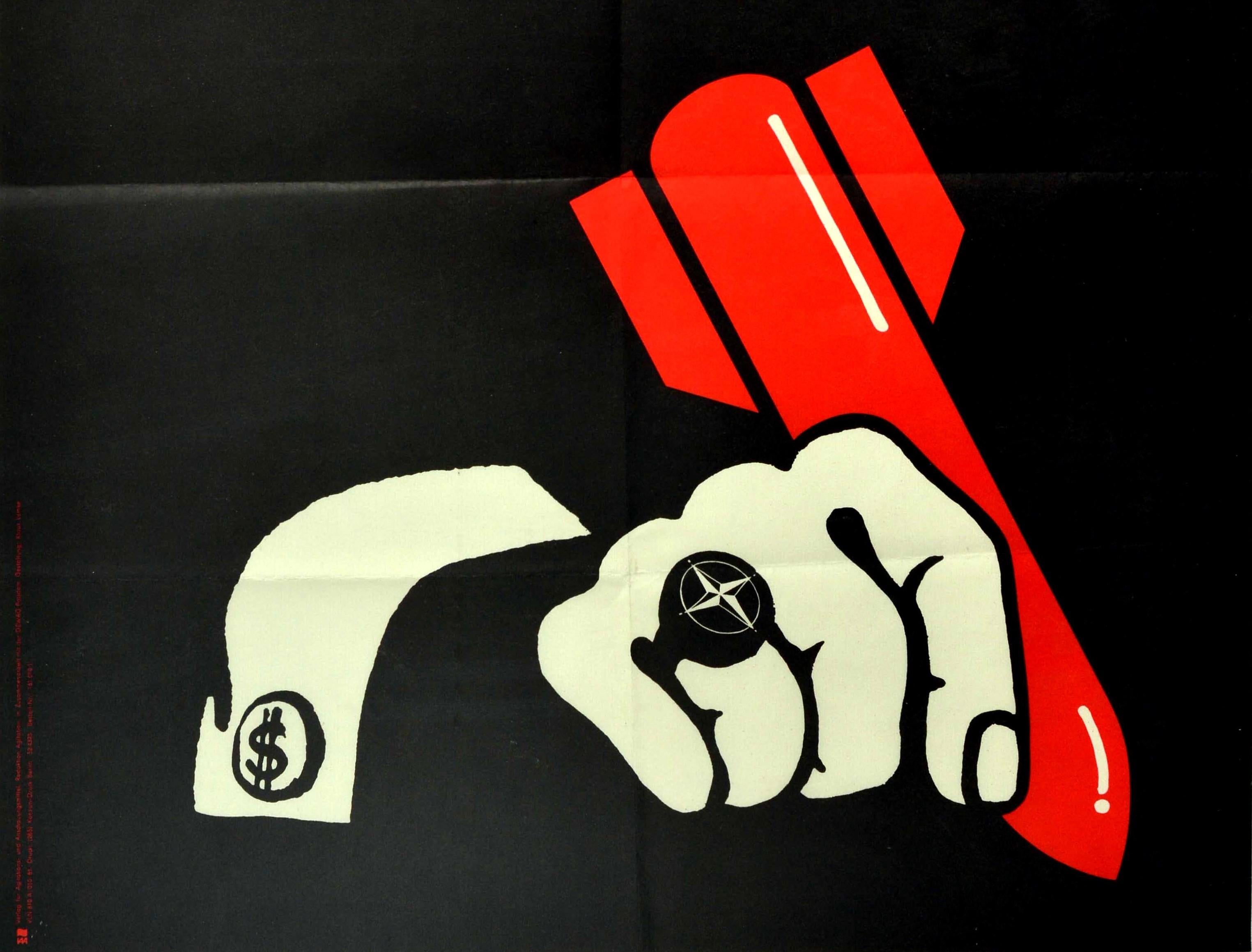 Original vintage political propaganda poster published in the German Democratic Republic - Die im dunkeln sieht man doch! You can see those in the dark! - featuring a dark background with a white hand wearing a ring marked with the NATO compass