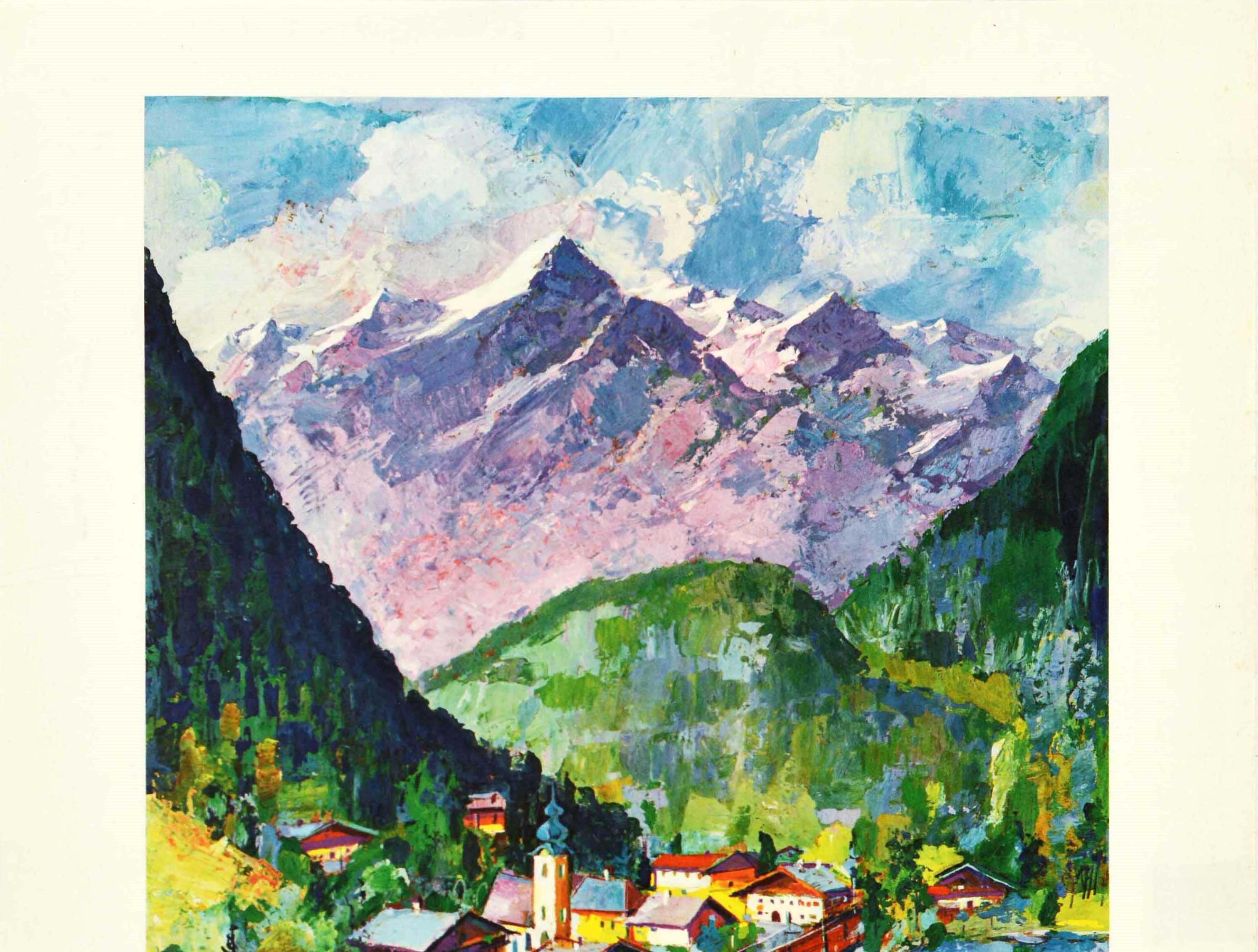 Original vintage travel poster for Austria issued by the Austrian Federal Railways featuring a scenic view of a train passing through a mountain valley with a small town and trees on the hills on one side of the tracks and a lake on the other, the