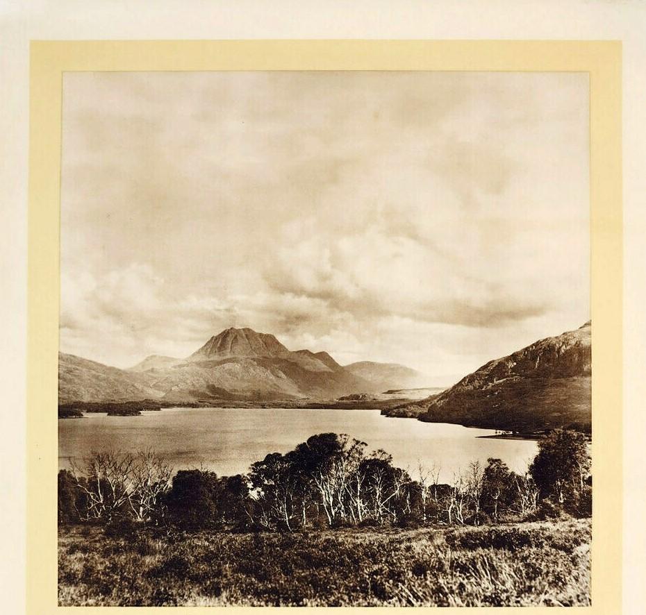 Original vintage LMS railway travel poster for Scotland featuring a scenic black and white photo of Loch Maree and Ben Slioch with a small illustration of Edinburgh Castle below and the stylised text reading: To Scotland by LMS (London Midland &