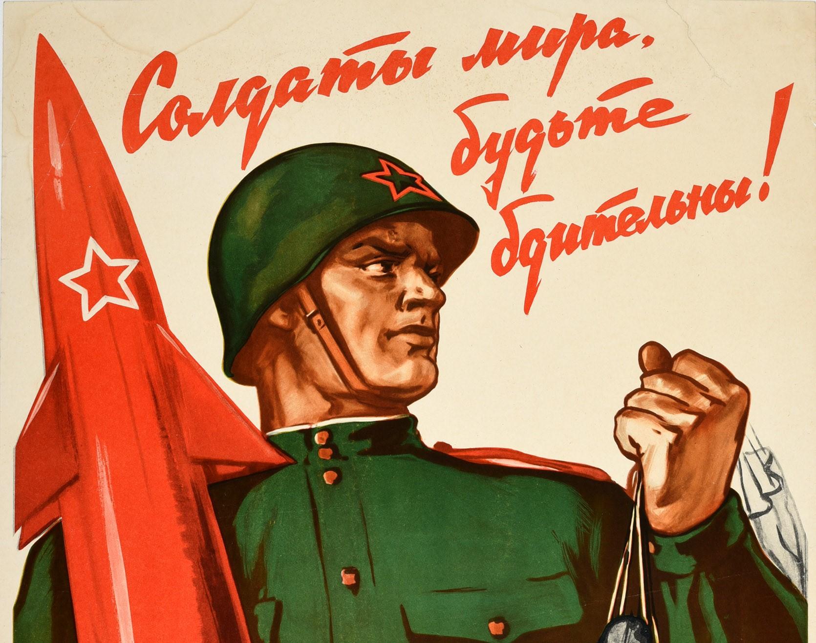 Original vintage Cold War era Soviet propaganda poster - Soldiers of the Peace, Be Vigilant! - featuring a dynamic image of a soldier in uniform holding a missile rocket marked with a Soviet star over a shoulder with one arm next to the bold red