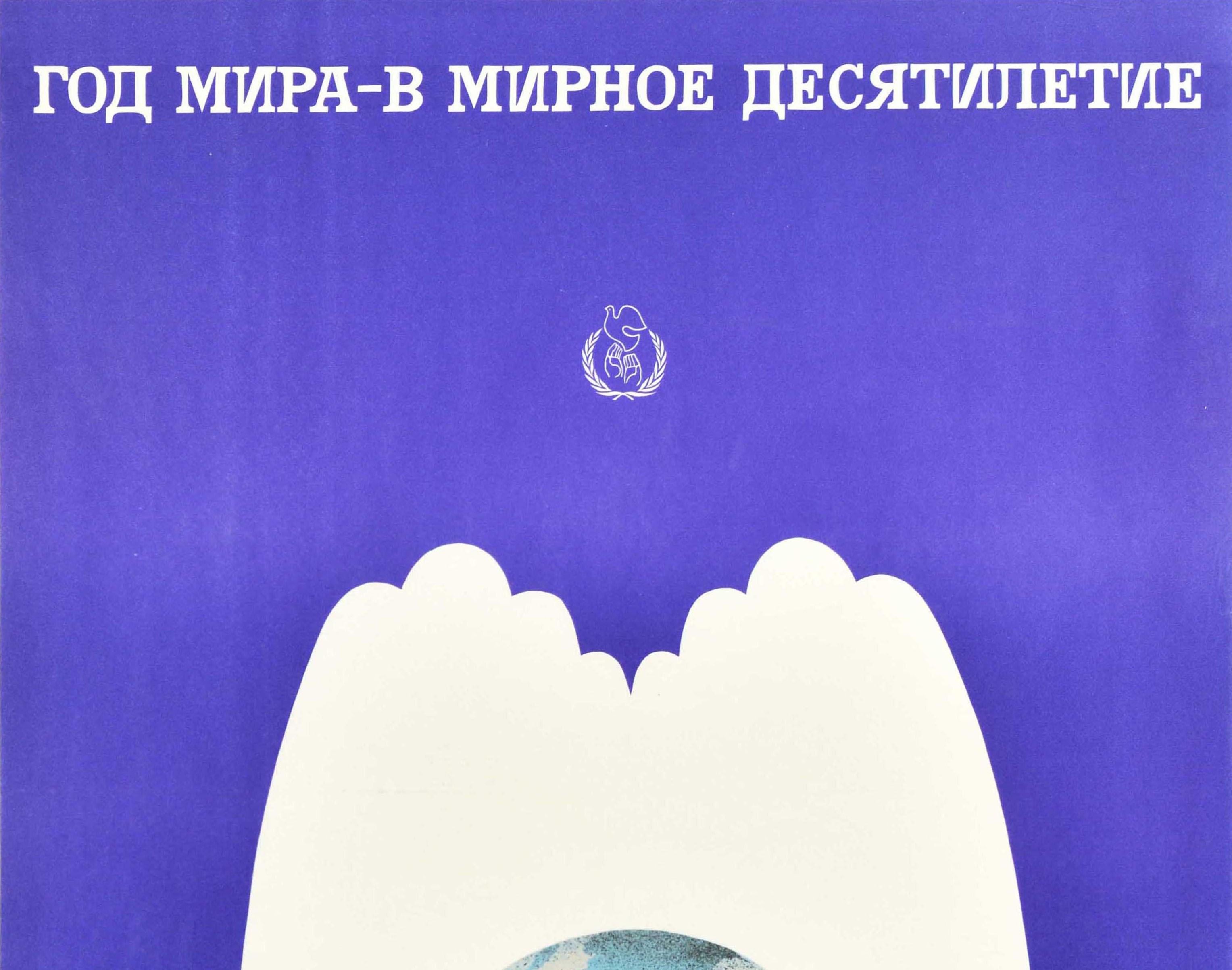 Original vintage Soviet propaganda poster for the International Year of Peace - Into A Peaceful Decade. Great design featuring two hands in the shape of white doves of peace holding a globe set on a blue background, the UN logo of hands releasing a