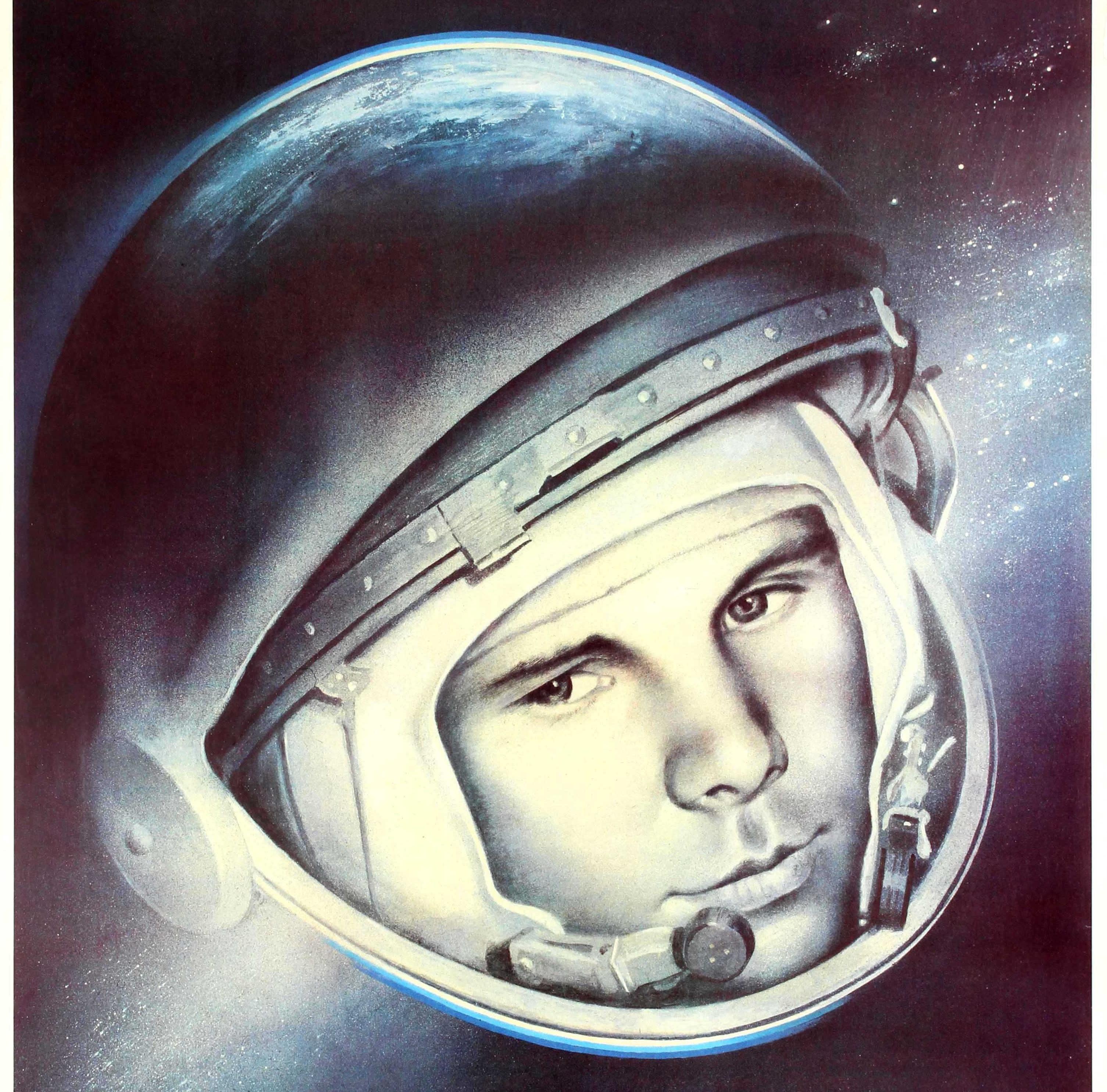 Original vintage Soviet propaganda poster featuring a great image of the first man in space - on 12 April 1961 - the pilot and cosmonaut Yuri Gagarin (Yuri Alekseyevich Gagarin; 1934-1968) with his helmet blending in to form the earth with stars in