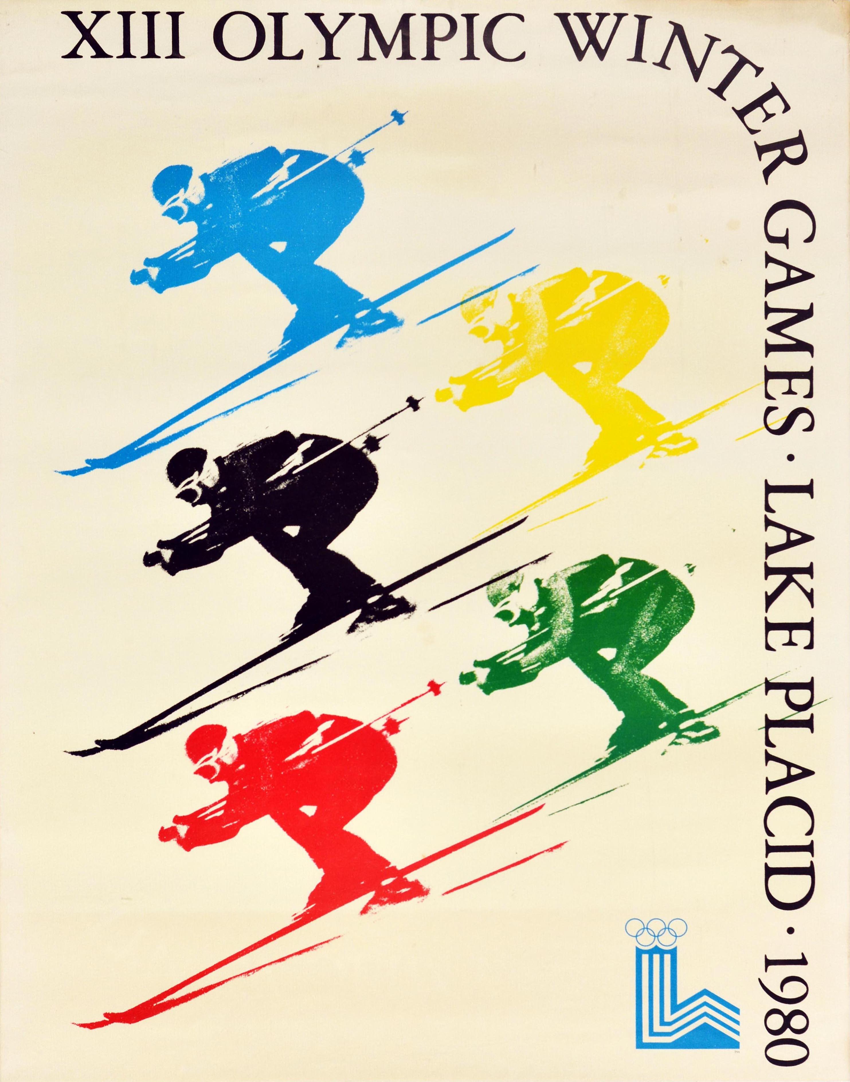 Original vintage sports advertising poster for the XIII Olympic Winter Games Lake Placid 1980 held in New York USA from 13-24 February featuring a dynamic illustration of skiers in colours of the Olympic rings - blue, yellow, black, green, and red -