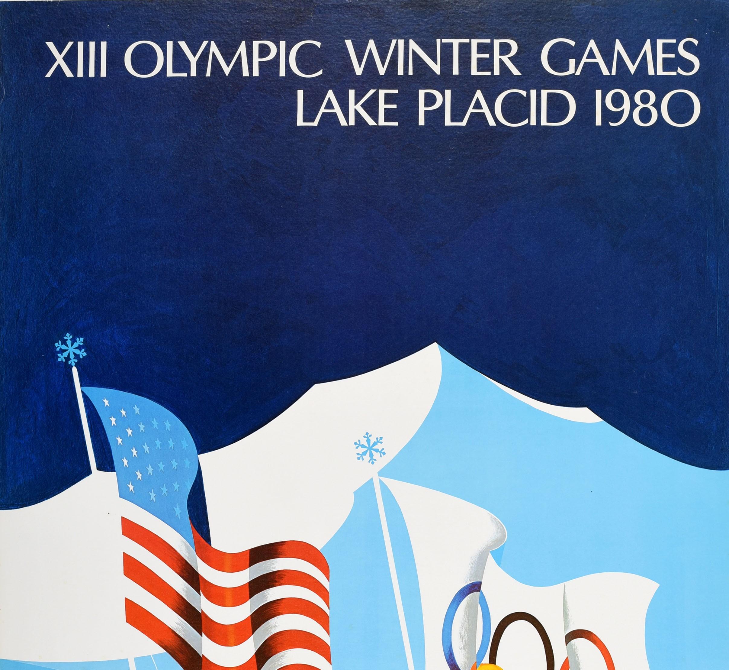 Original vintage sport poster for the XIII Olympic Winter Games Lake Placid 1980 held in New York USA from 13-24 February featuring the United States stars and stripes flag and the Olympic rings flag flying on poles topped with snowflakes in front