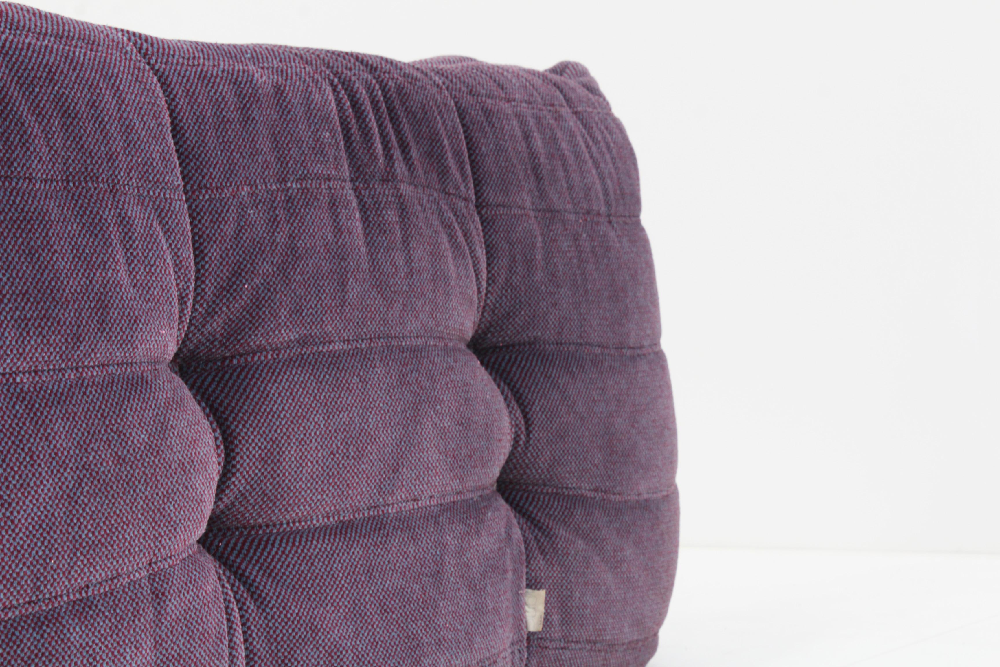 Original vintage Togo 2 seater sofa  by Ligne Roset designed by Michel Ducaroy. This is an original togo sofa in purple fabric. No reupholstery. The fabric and foam are in a good vintage condition, some signs of wear appropriate with age.
