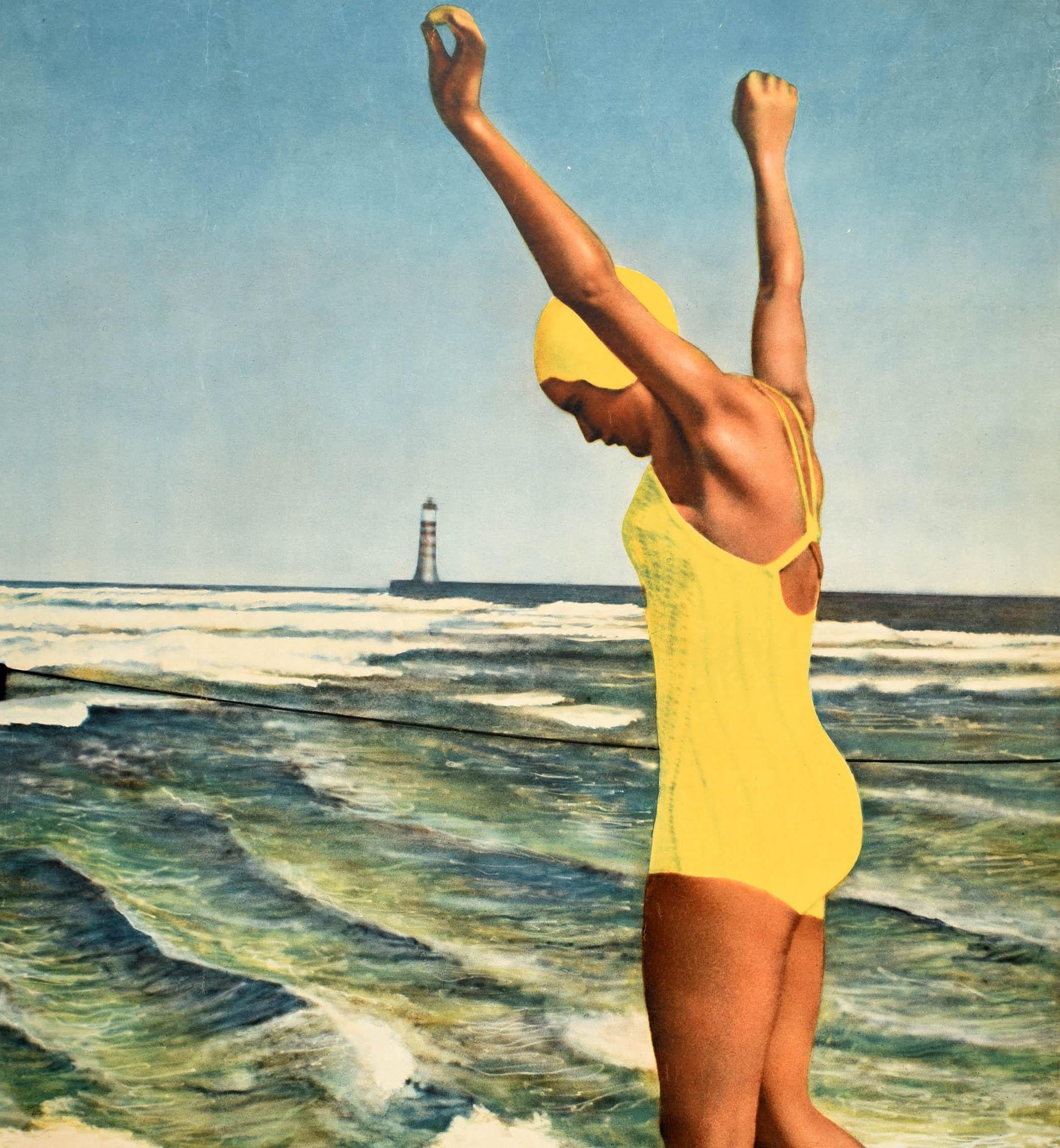 Original vintage travel poster - A Sunny Holiday on the German Coast - featuring a lady in a yellow swimming costume with a swim hat and beach shoes walking into the sea with her arms raised, a rope marking the safe swimming area for the summer