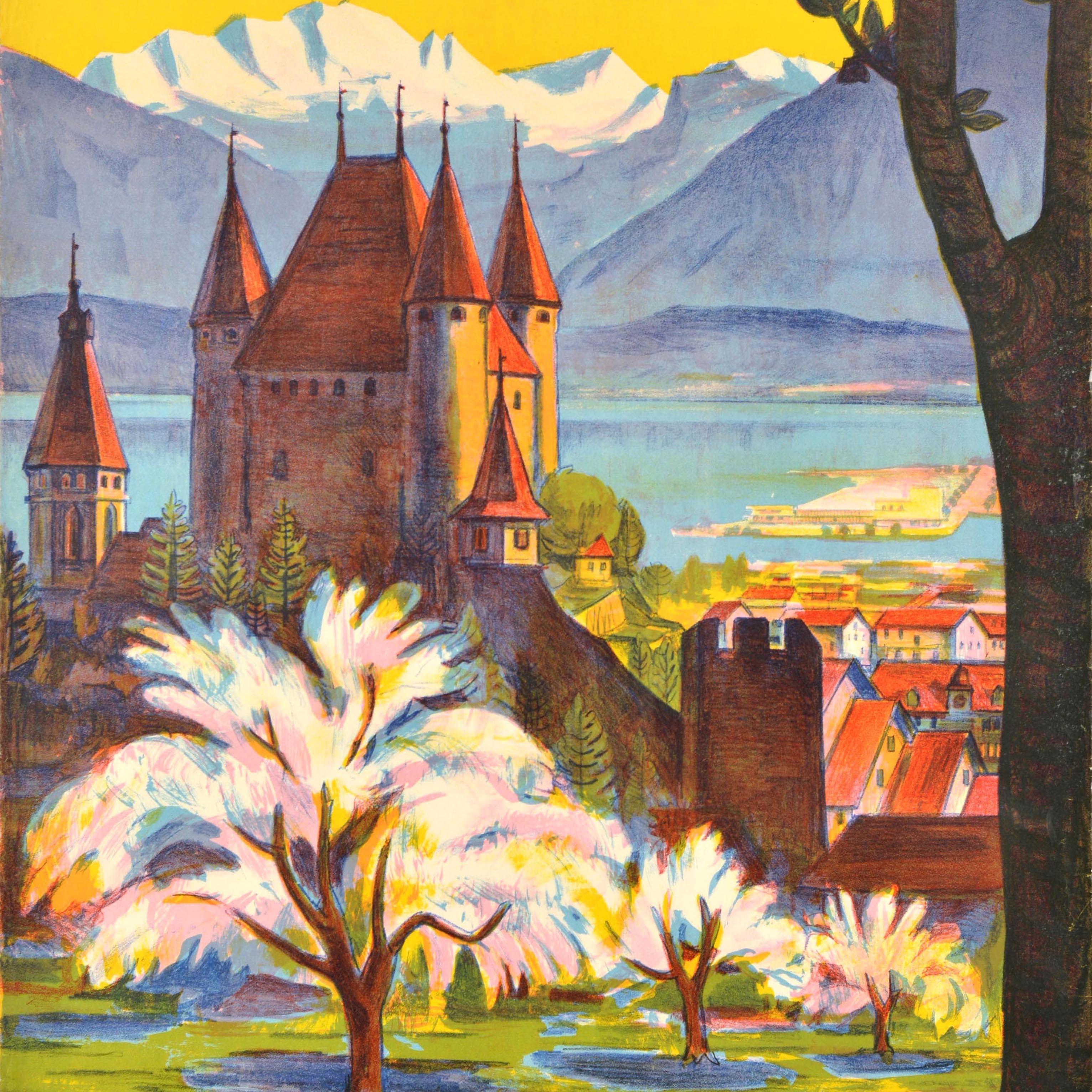 Original vintage travel poster for the historic Swiss town of Thun in the Bernese Oberland region featuring a colourful illustration depicting a scenic view of the 12th century Schloss Thun Castle with trees in the foreground and the snow topped