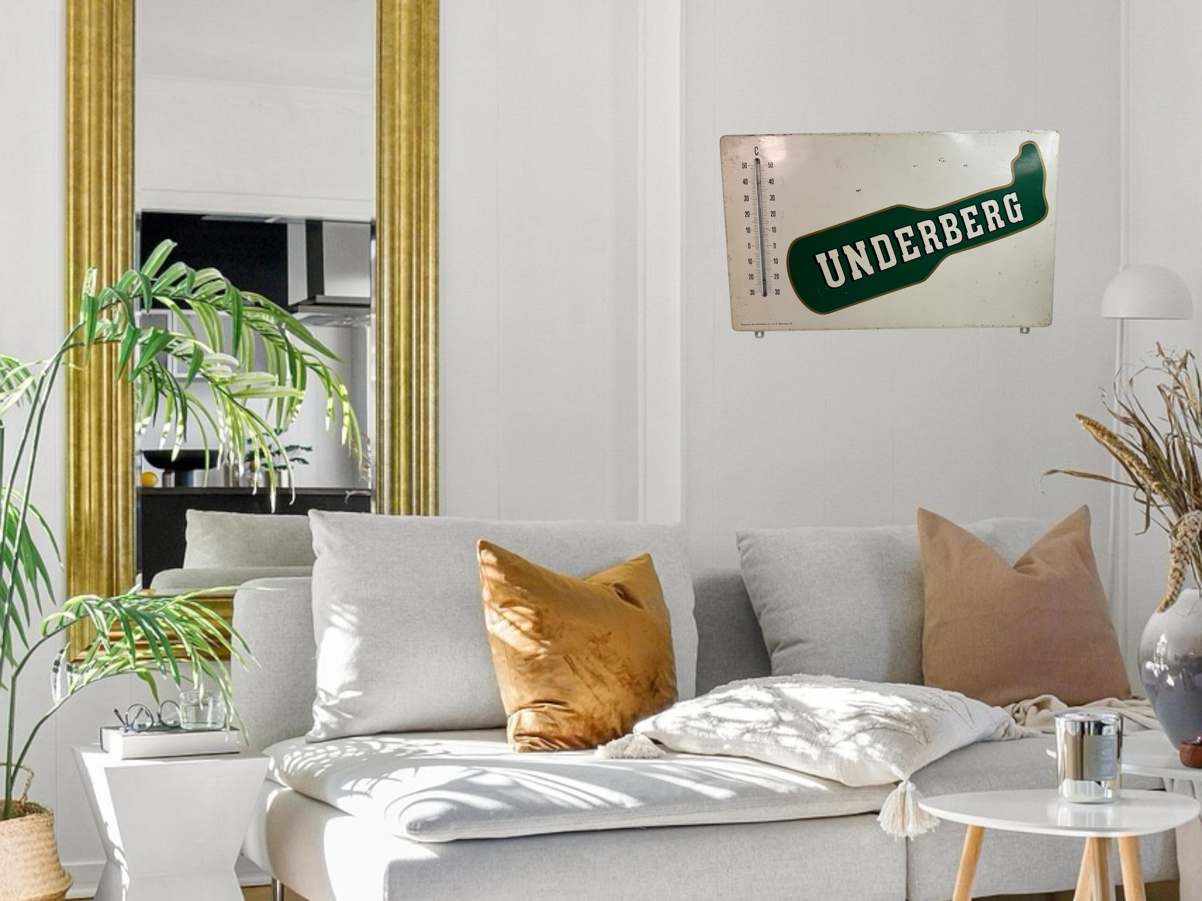 A beautiful metal Underberg Bitter Advertising sign with Thermometer. It is featuring a great image of the Underberg bottle. signed with underbred gumbo. Good condition, staining, creasing, tears. Found at an Estate Sale in Nuremberg, Germany. A