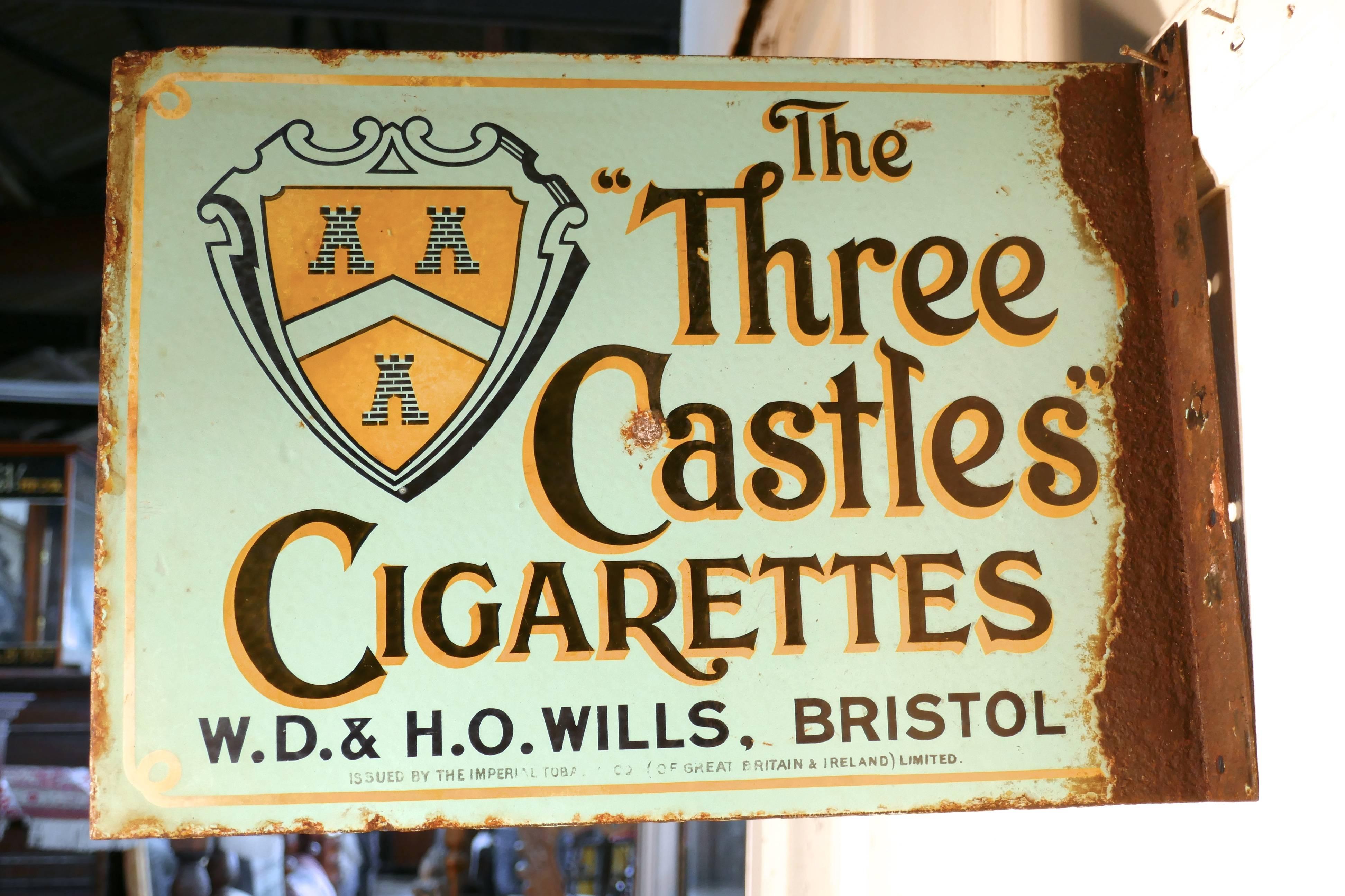 Original Wills cigarette pictorial advertising enamel sign 

Very rare old sign, blue background, bright yellow and black writing advertising The Three Castles Cigarettes, WD & HO Wills Bristol
This is a double sides sign, that has right angle