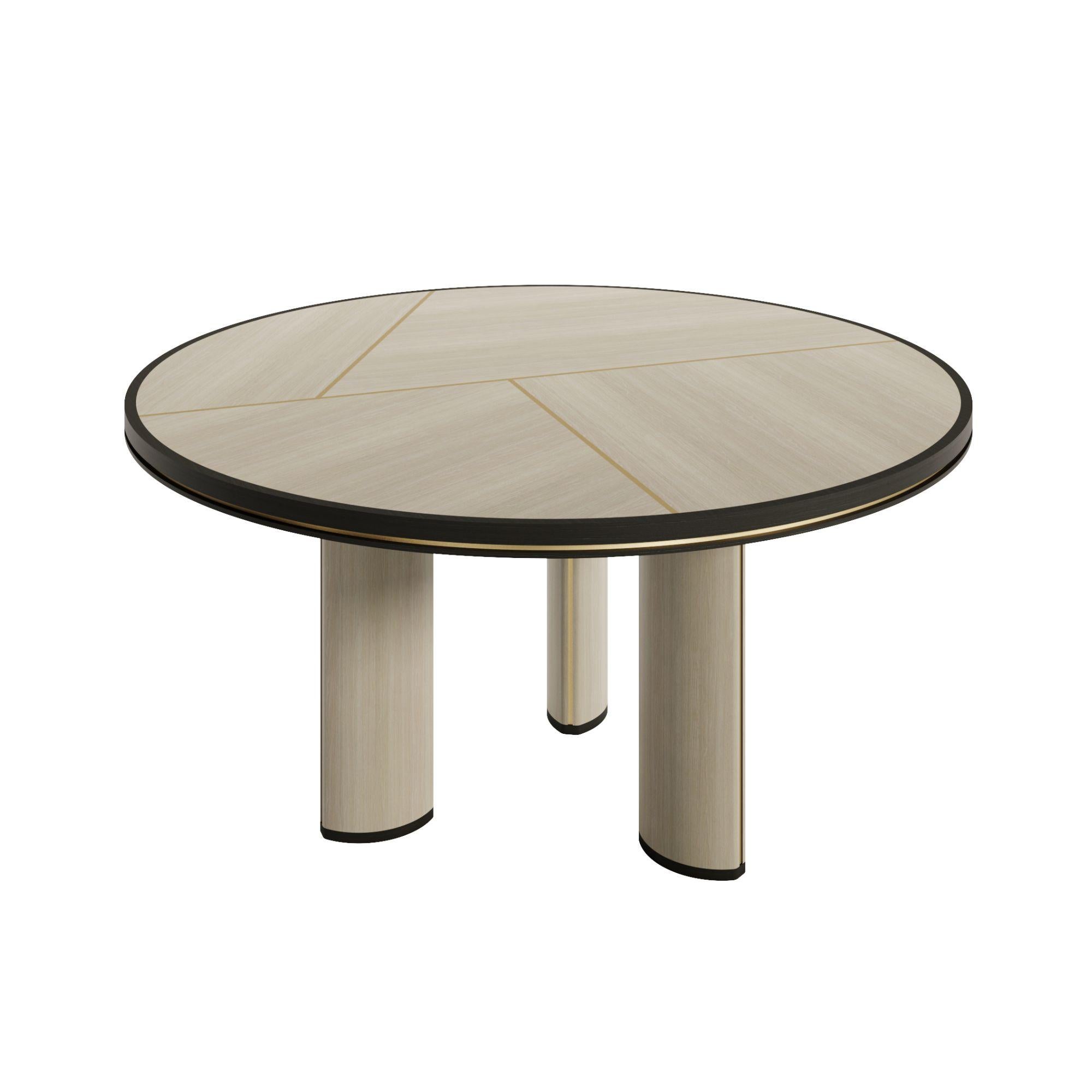 Elegant design. Artisanal detail.

The Orion dining table is a standout piece, with a handcrafted geometric top that is a refined composition of natural wood veneers and antique brass accents. Its round shape and sculptural base bring warmth and
