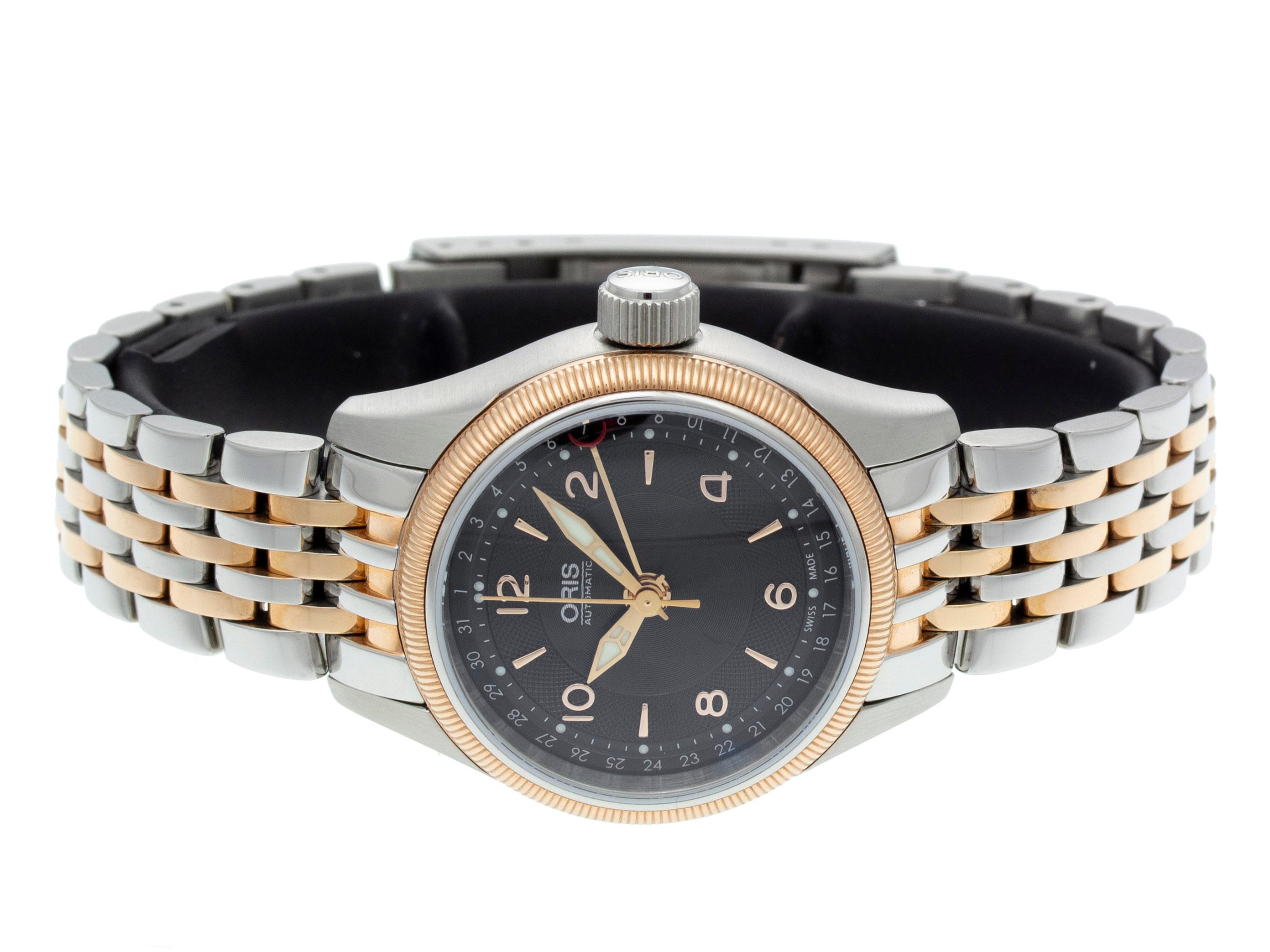 Stainless Steel & Rose Gold PVD Oris Big Crown Pointer Date Automatic Watch with a 29mm Case, Black Dial, and Bracelet with Deployment Buckle. Features include Hours, Minutes, Seconds, and Date. Comes with a Deluxe Gift Box and 2-Year Store