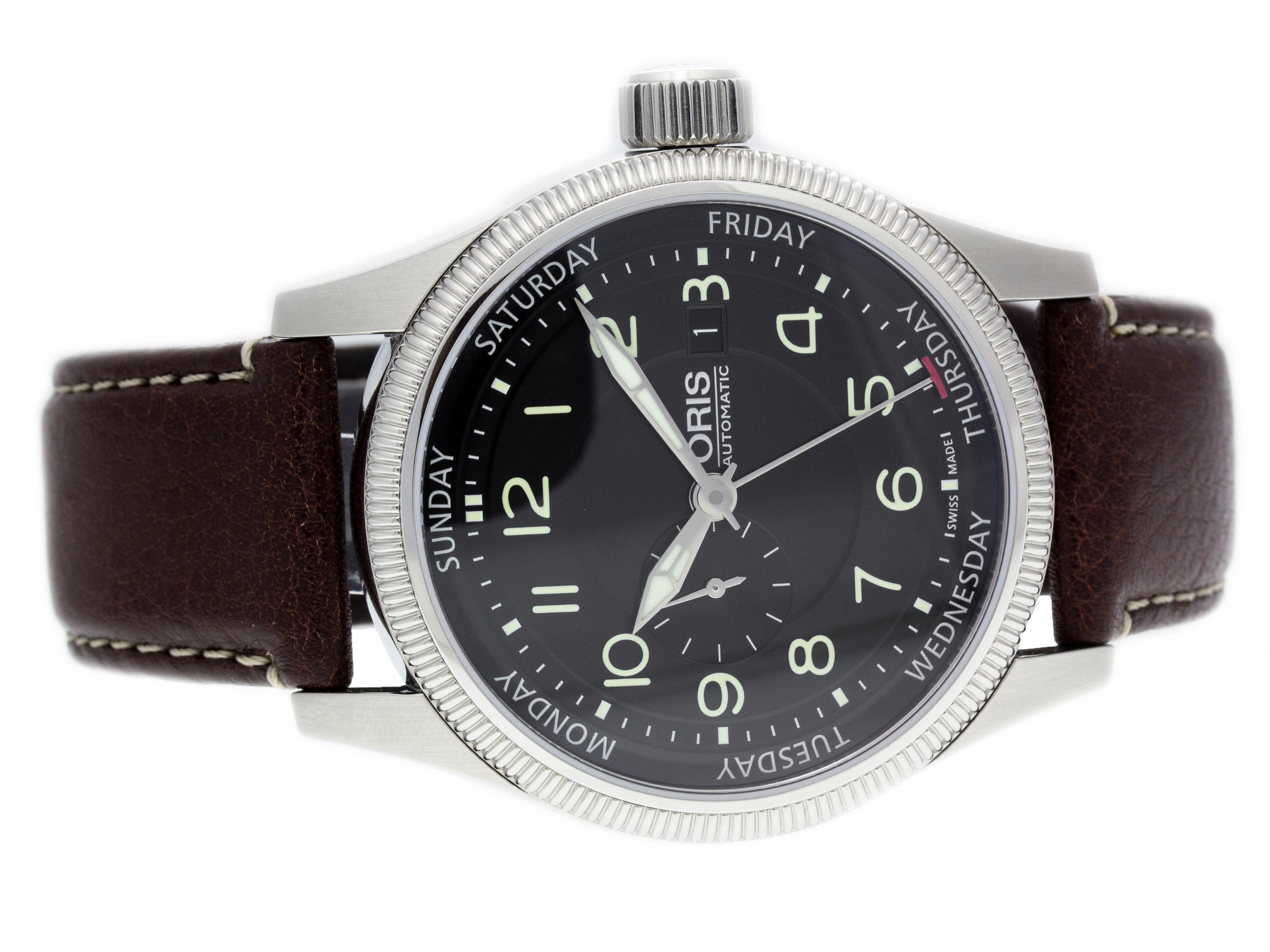 Stainless steel Oris Big Crown ProPilot automatic watch with a 44mm case, black dial, and brown leather strap with deployment clasp. Features include hours, minutes, seconds, day, and date. Comes with a Deluxe Gift Box and 2 Year Store