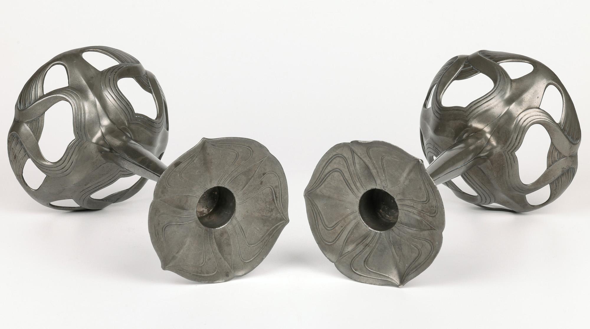 A stunning and exceptional pair German Jugendstil (Art Nouveau) pewter floriform candlesticks by renowned makers Orivit and dating from around 1900. The candlesticks, made in Cologne, Germany stand raised a large domed root work pierced bases