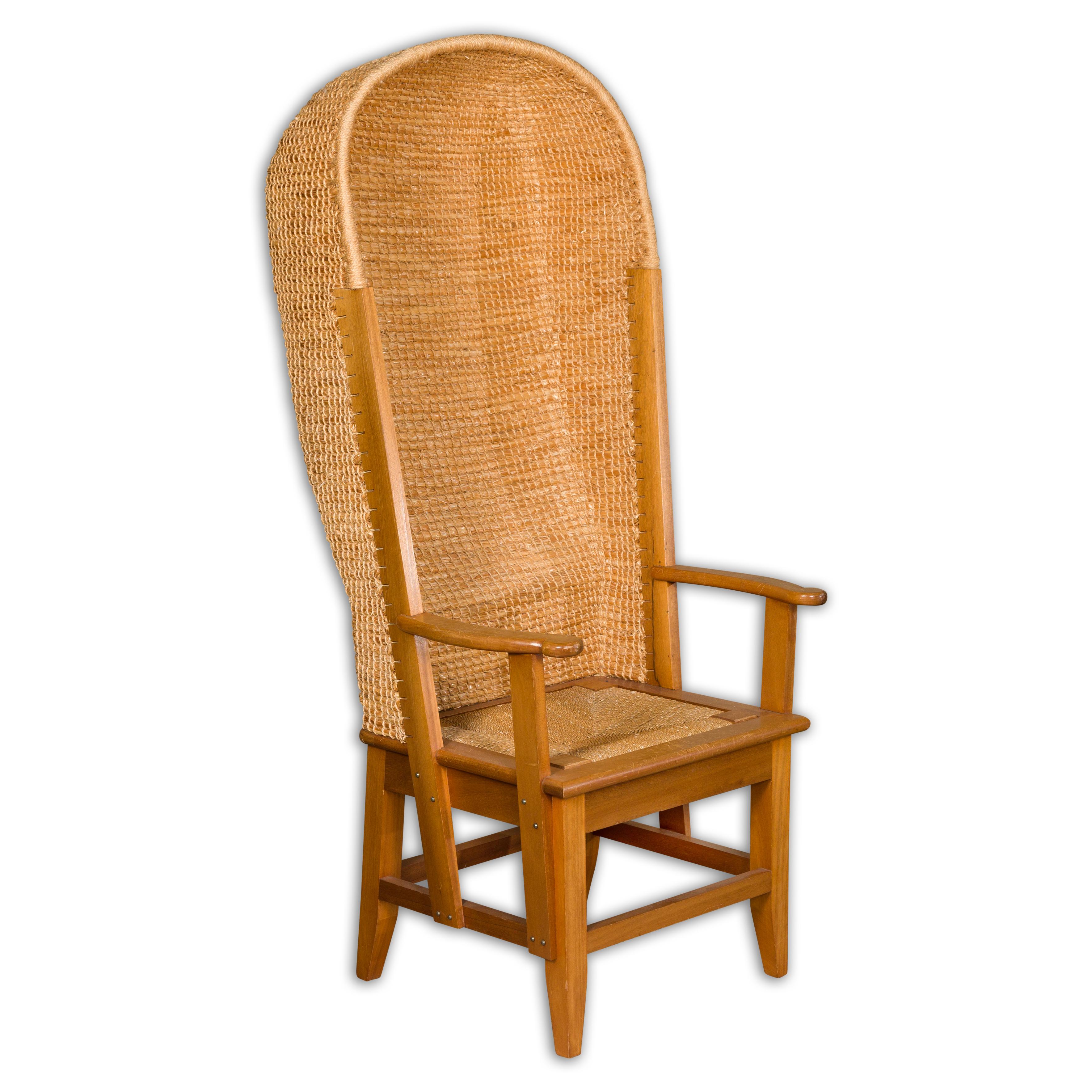 A Scottish Orkney Island canopy chair from the mid 20th century with handwoven straw hooded back, rush seat, open serpentine arms, tapered legs and side stretchers. A charming Scottish Orkney Island canopy chair from the mid-20th century, seamlessly