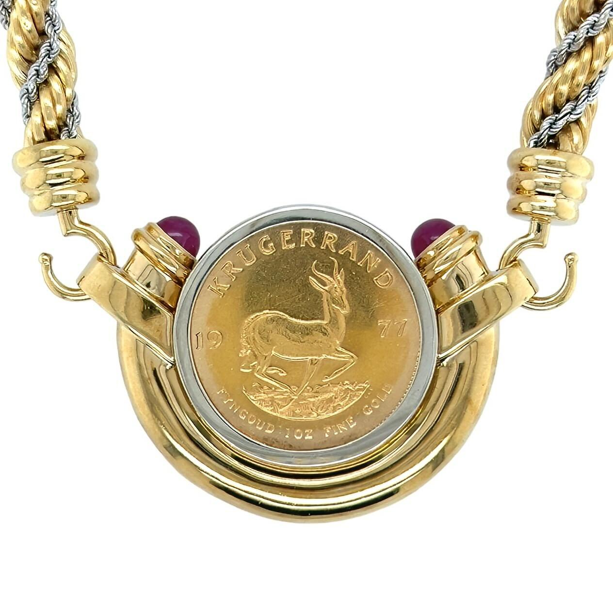 An 18 karat yellow and white gold, ruby and coin necklace, Orlanda Olsen.  Designed as a white gold bezel set Krugerrand enclosed within a yellow gold half bezel set at each terminal with a round cabochon ruby measuring approximately 6.96 mm,