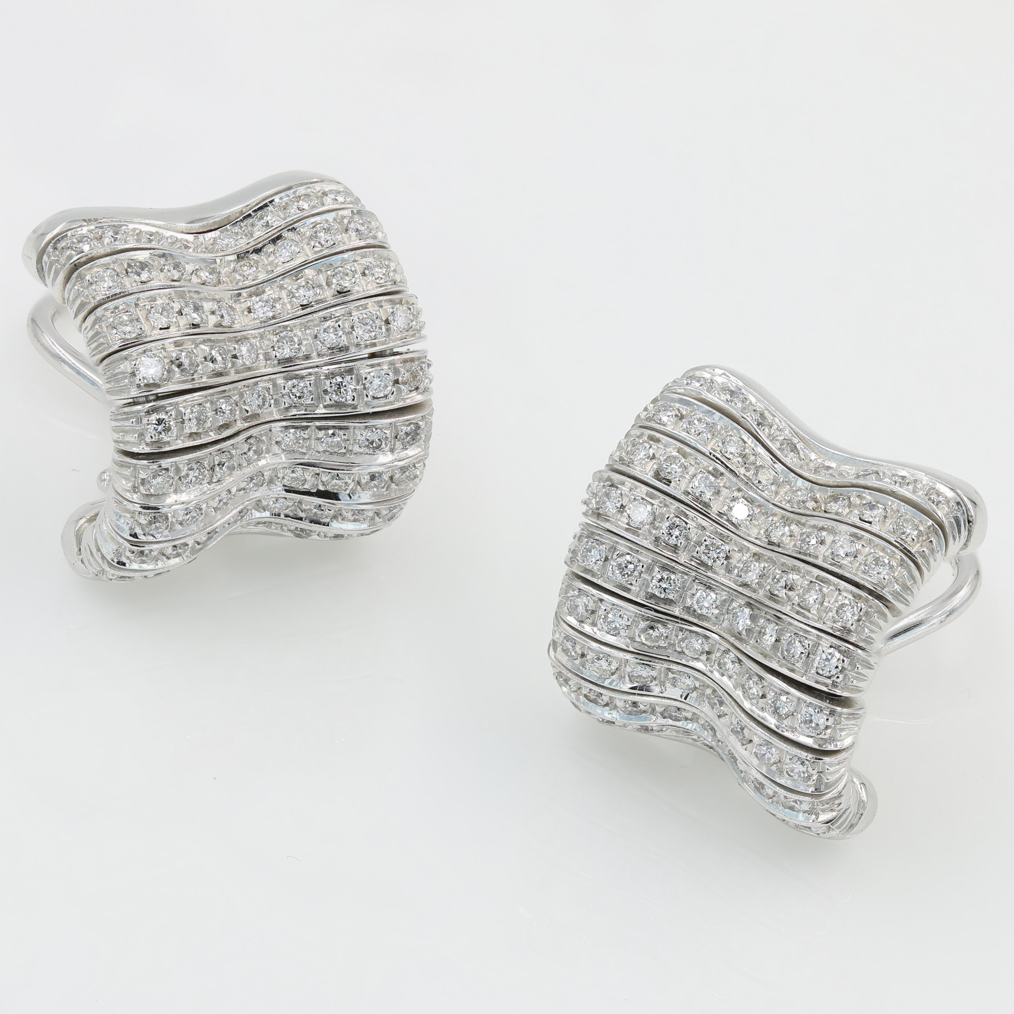 18kt White Gold and Diamond Earrings by Orlandini - 144 round cut diamonds weight about 1.00tw.  These earrings are pre-owned (restored to new condition). They feature Omega clip backs and posts.  