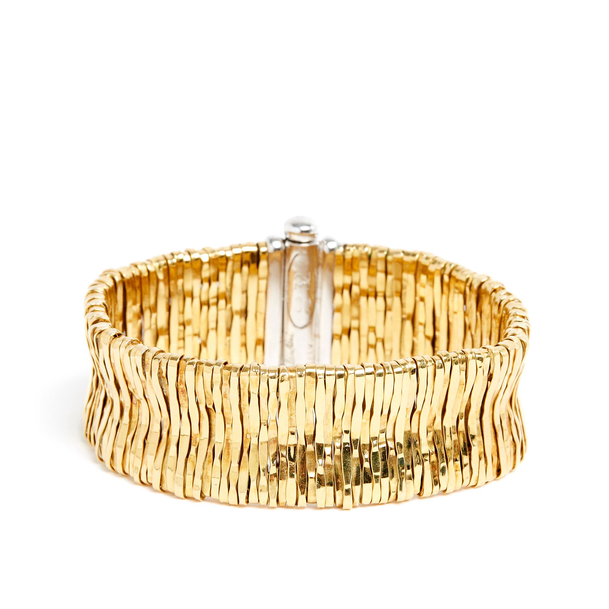 Orlandini bracelet (Orlando Orlandini) flexible yellow gold mesh style cuff with white gold clasp inlaid with small brilliant-cut diamonds, numbered 32, signed. Total length 18 cm, width 2 cm, weight 75.76 gr. The bracelet is in very good condition