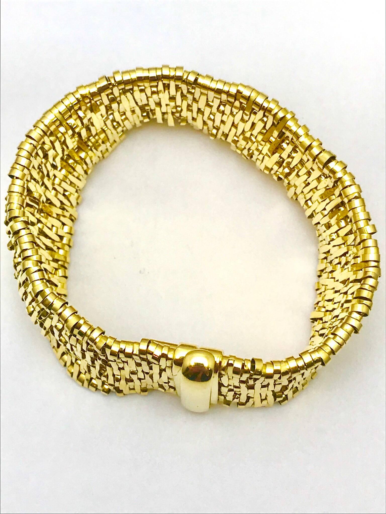 An Orlando Orlandini Fiandra wide woven link 18 karat yellow gold bracelet. The bracelet is made up of small woven links, creating a very soft feel to the skin. It has a push clasp with a safety lock. 81.35 grams.

Signature: Orlandini
Hallmark: