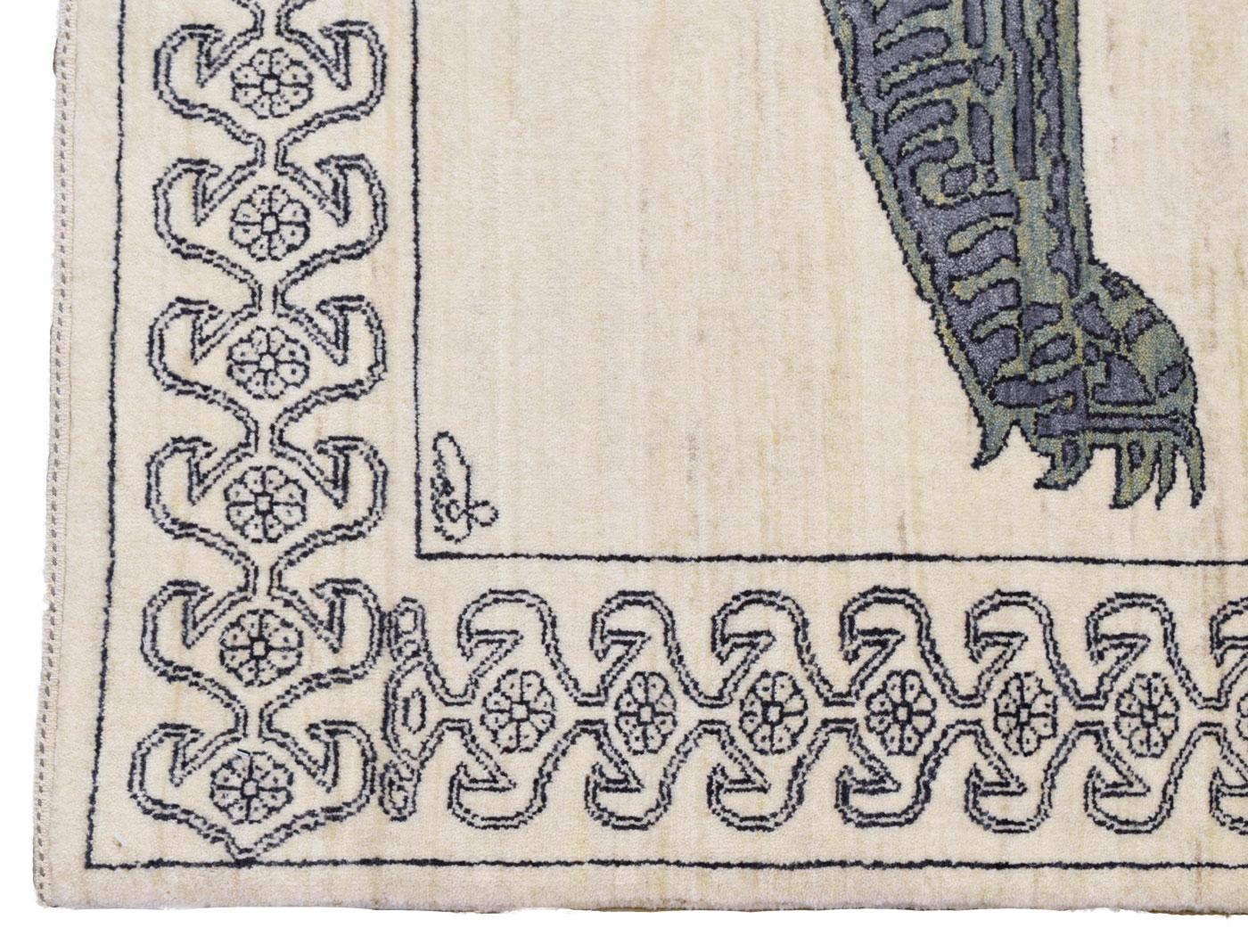 With a large distinct green and gray lion motif, this hand-knotted wool carpet, 