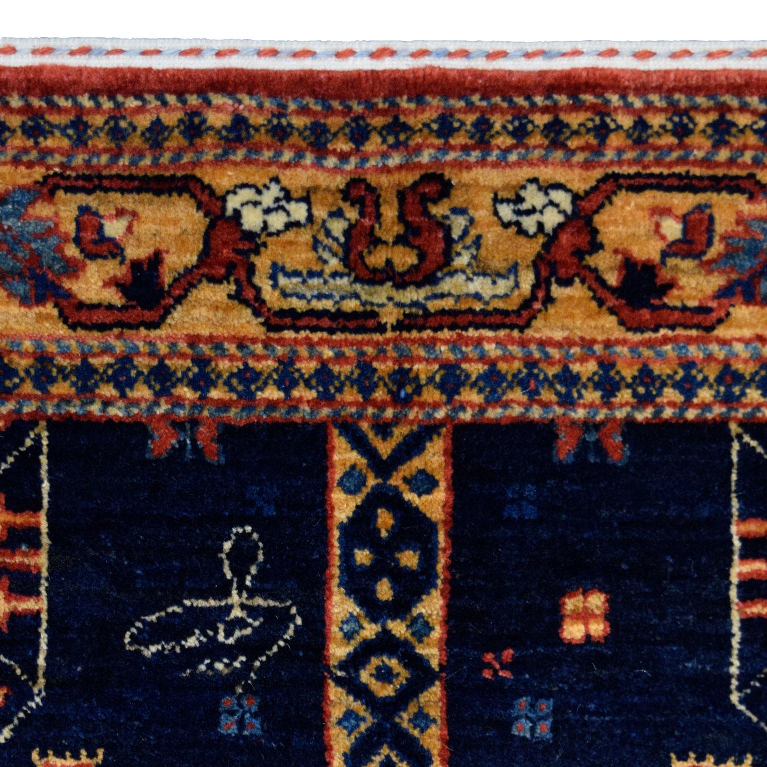 This Orley Shabahang Qashqai carpet from the Tribal Collection measures 4’2” x 6’2” and showcases an exquisite Qashqai design in indigo, gold, red, and cream wool. Hand-knotted in pure wool, Orley Shabahang’s signature Shekarloo weave produces a