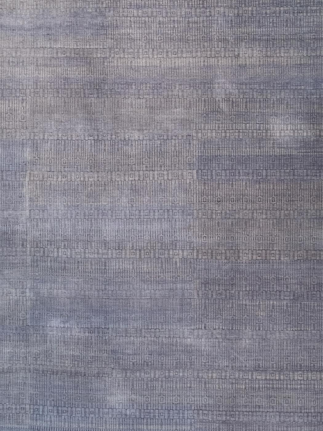 In soft, subtle, and subdued shades of light gray, this minimalist architectural carpet titled Excelsior measures 9’ x 12’ and belongs to the Orley Shabahang Architectural Collection. Hand-knotted in Orley Shabahang’s Persian-inspired Amritsar