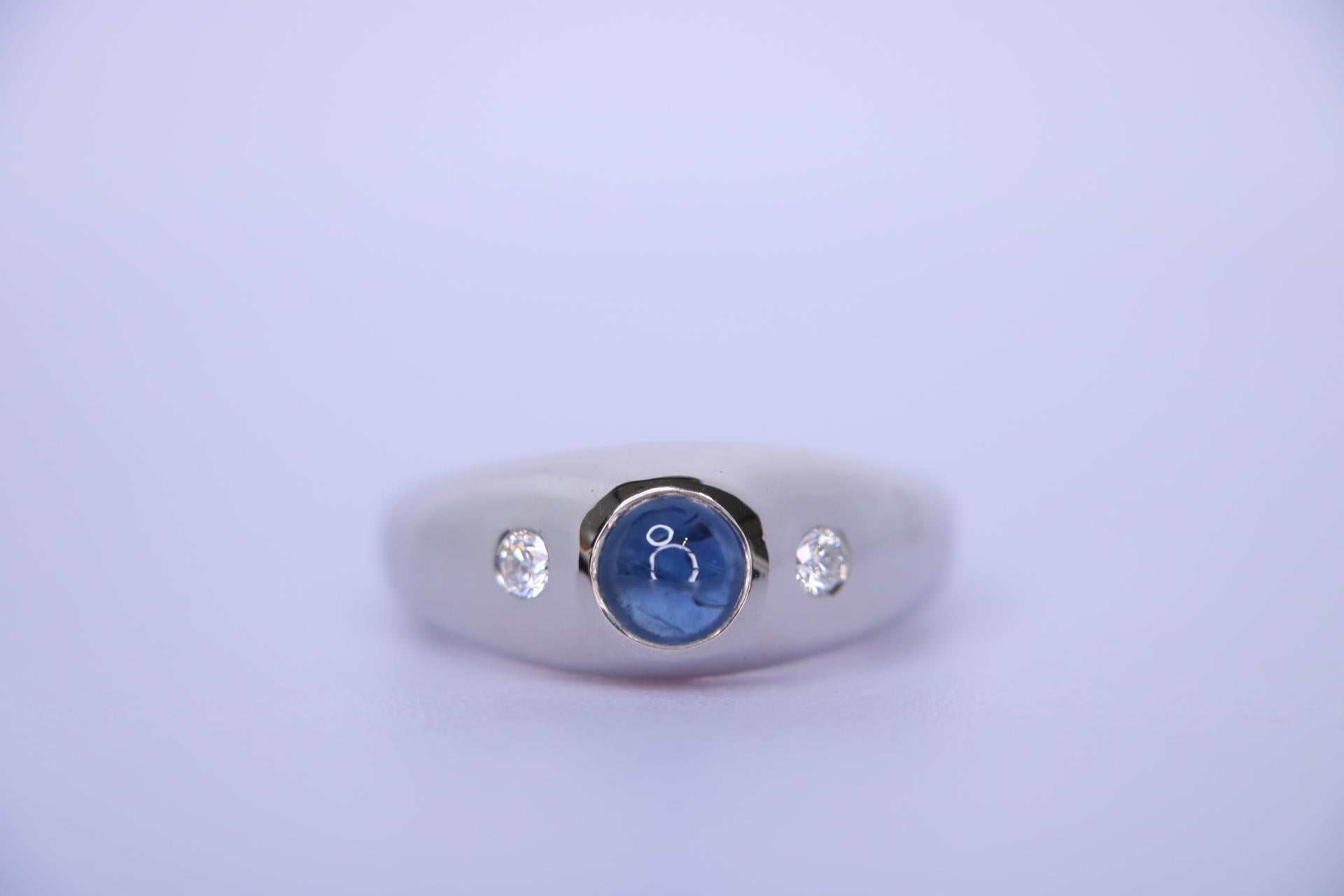 Orloff of Denmark; 925 Sterling Silver Ring set with a 1.07 carat Natural Blue Sapphire and two Natural White Diamonds.

This sterling silver ring features a 1 carat cabochon sapphire, known for its deep blue color, which has been heat-treated to