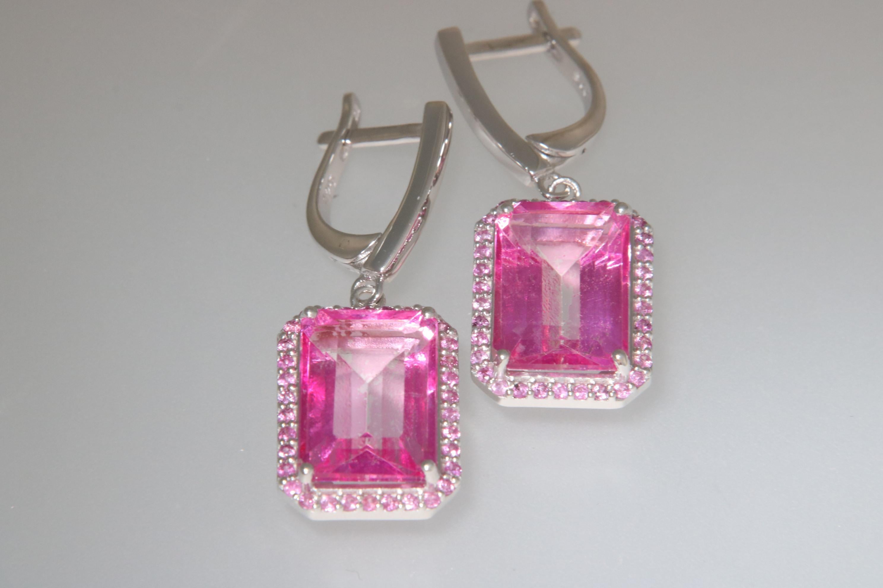 Orloff of Denmark; Blue Topaz and Sapphire Earrings fashioned out of 925 Sterling Silver.

Dazzle with the vibrant charm of these pink topaz and pink sapphire earrings, elegantly set in 925 sterling silver. The earrings showcase emerald-cut pink