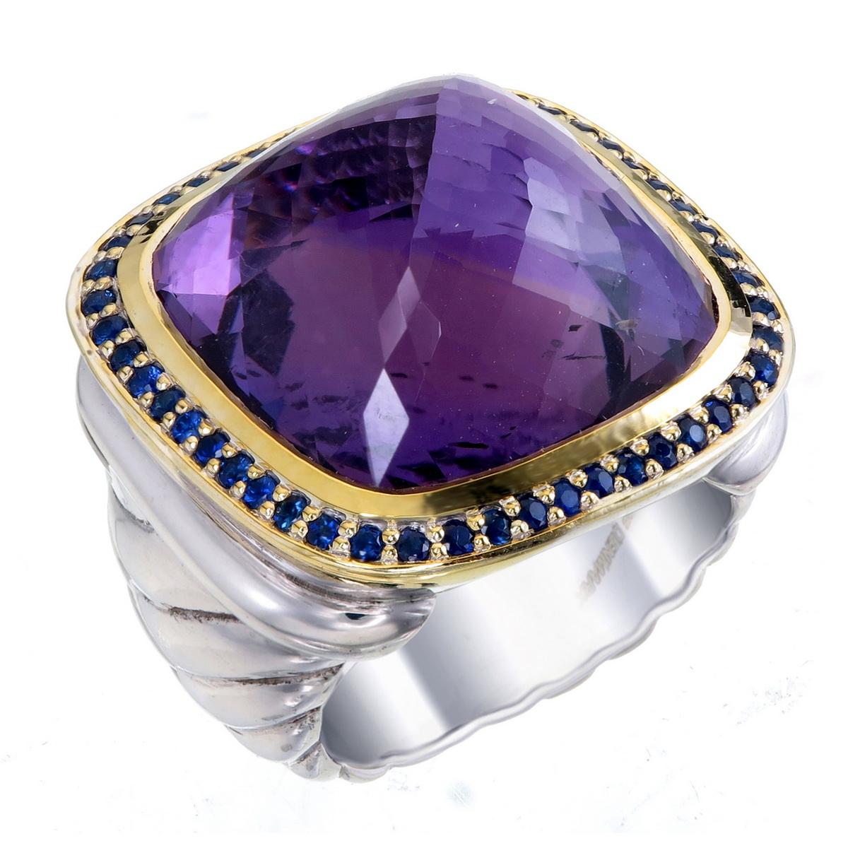 Orloff of Denmark; Sterling Silver Statement ring featuring a total of 0.50 carats of Blue Sapphires surrounding a huge Amethyst, set in an 18 Karat Gold-Plated bezel

Introducing a striking statement ring crafted in 925 silver with an opulent 18