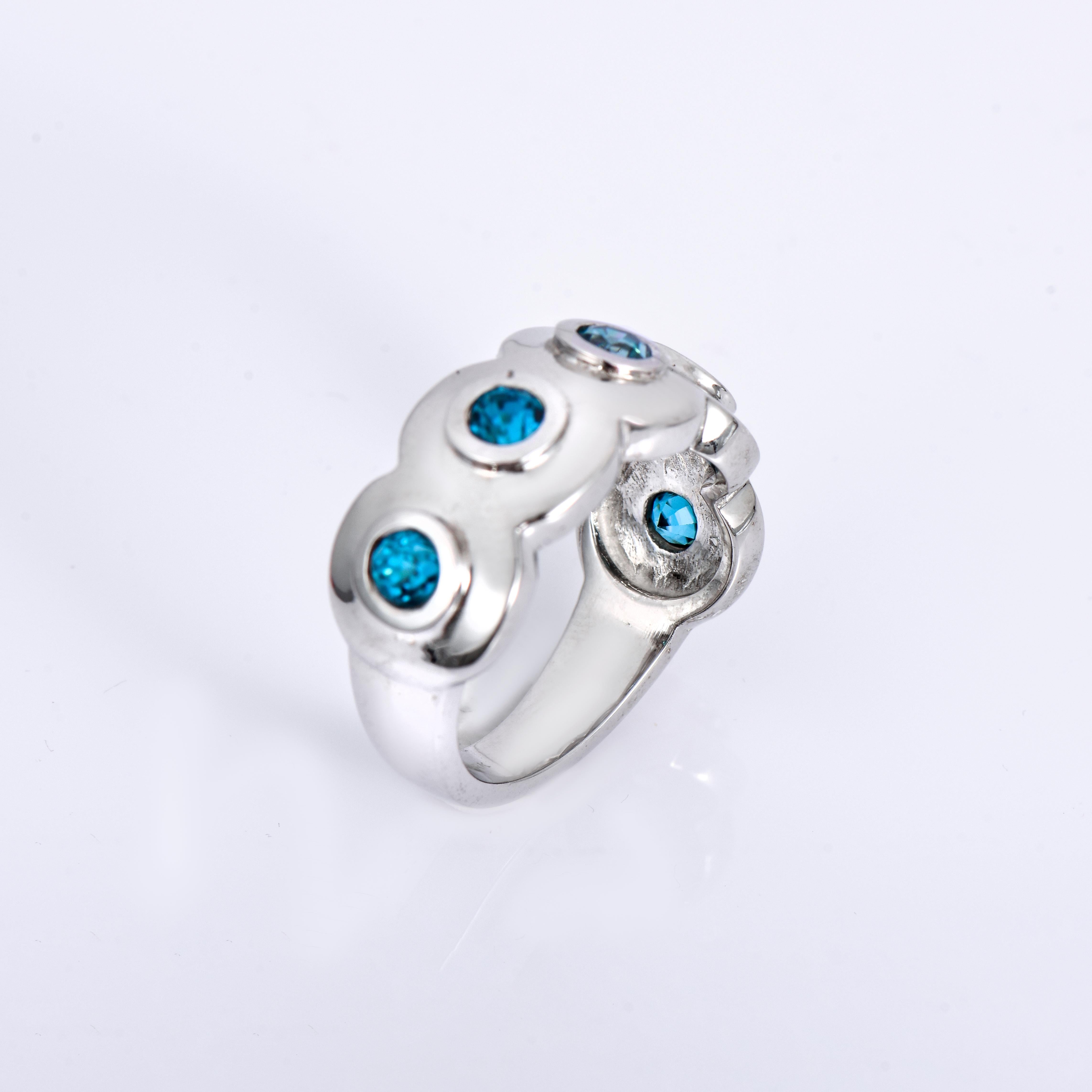 Orloff of Denmark; 925 Sterling Silver Ring set with 5 Natural Cambodian Blue Zircons totaling to 2.80 carats.

This handcrafted 925 sterling silver ring presents a lovely array of natural Cambodian blue zircons. The blue zircons, with their