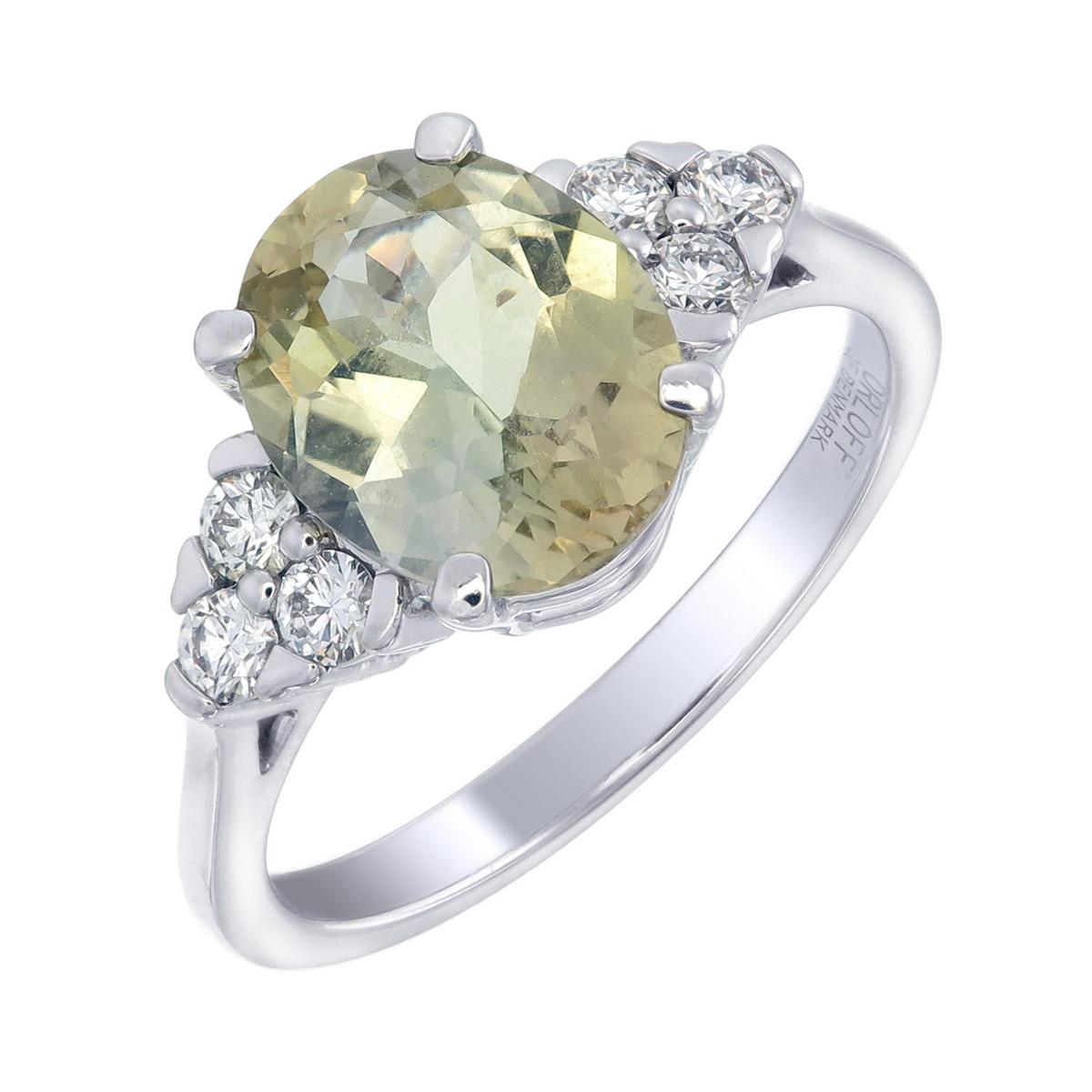 Orloff of Denmark's own; 
Captivate onlookers with the unique allure of this 2.83 carat Yellowish-Green Zoisite Diamond Ring. Set in the pristine elegance of 18 Karat white gold, this ring features a magnificent zoisite gemstone at its heart,