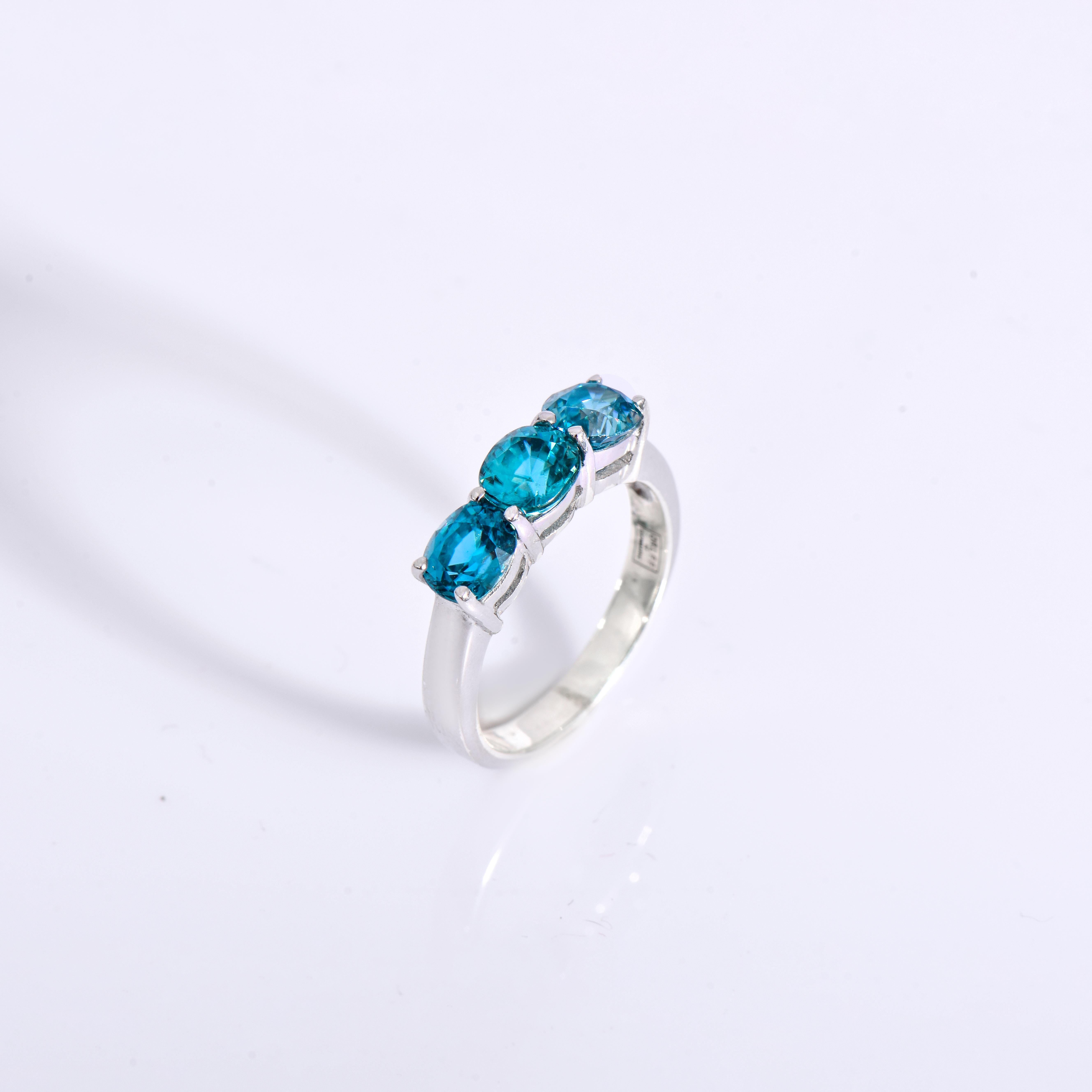 Orloff of Denmark; 925 Sterling Silver Ring set with three Natural Cambodian Blue Zircons totaling to 3 carats.

This piece has been meticulously hand-crafted out of 925 sterling silver.
In the center sits three 1 carat blue zircons, mined, polished