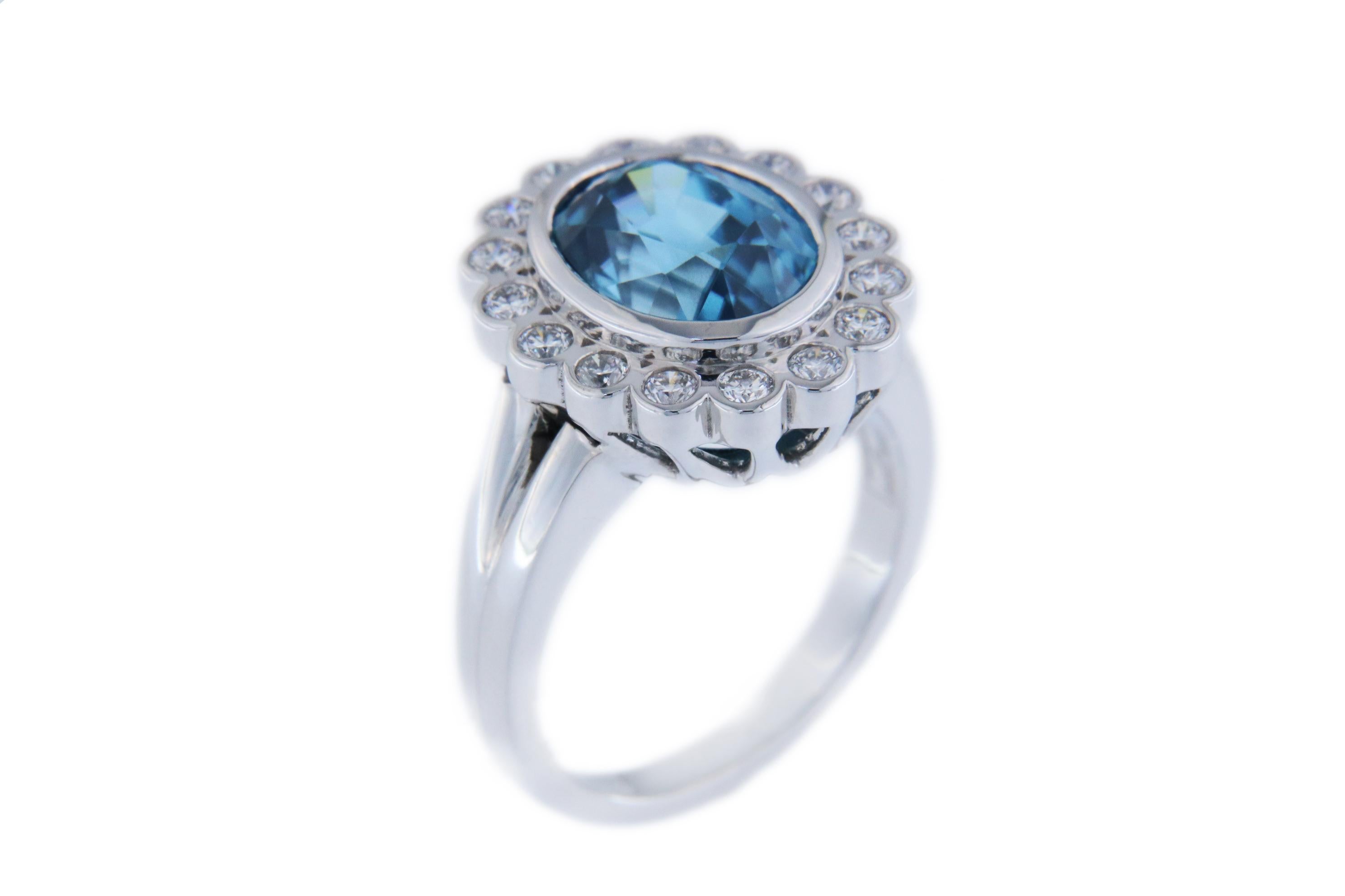Orloff of Denmark's own; 
This captivating 6.171 carat Blue Zircon ring, set in high-quality Rhodium-Plated Sterling Silver, is a true statement of elegance. The centerpiece, a stunning Blue Zircon with a deep ocean hue, is complemented by sixteen