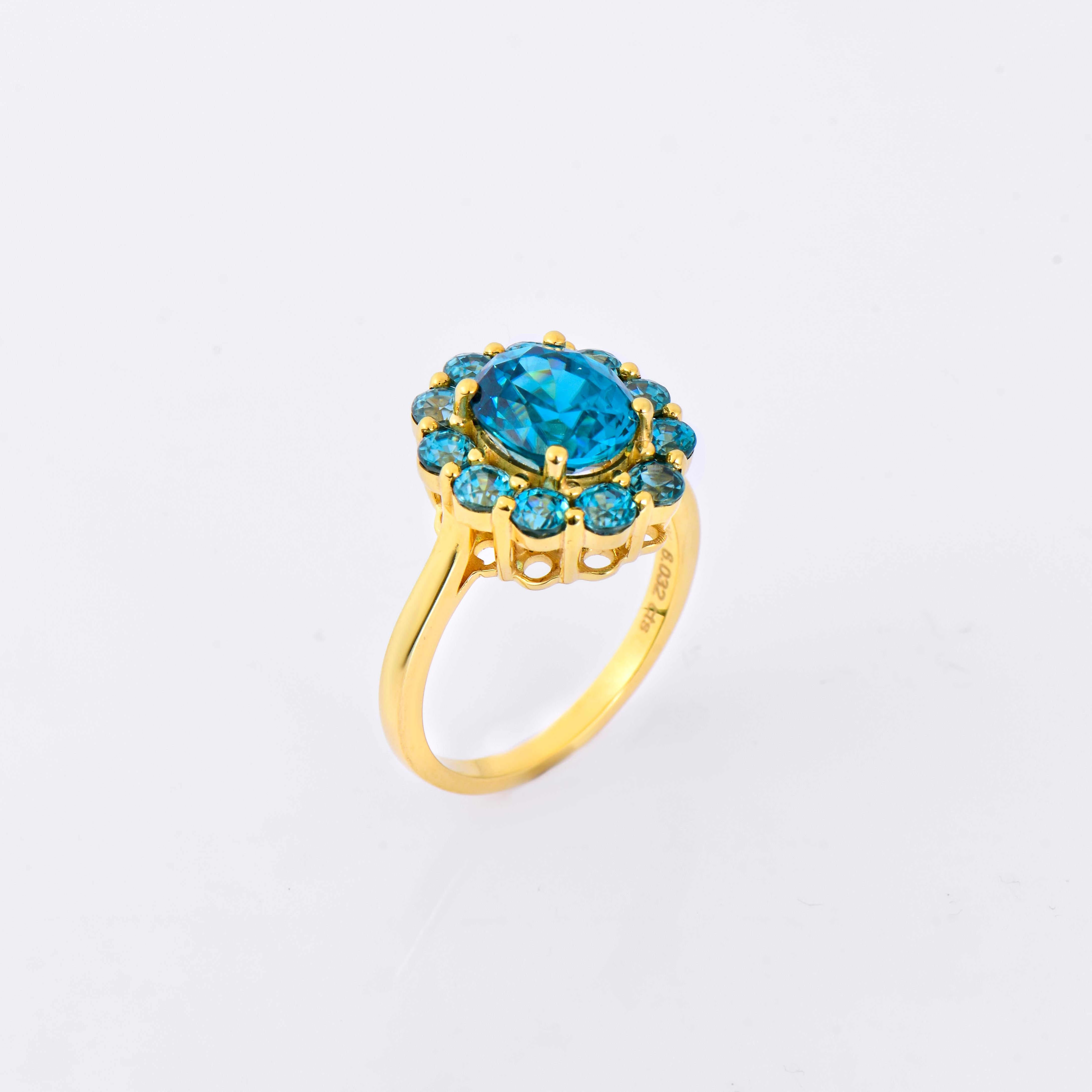 Orloff of Denmark; 10 Karat Gold Ring set with 12 Natural Cambodian Blue Zircons totaling to 6 carats.

This exquisite piece is a 10-karat gold ring, gracefully set with radiant Cambodian blue zircons that exude luxury and elegance. The central