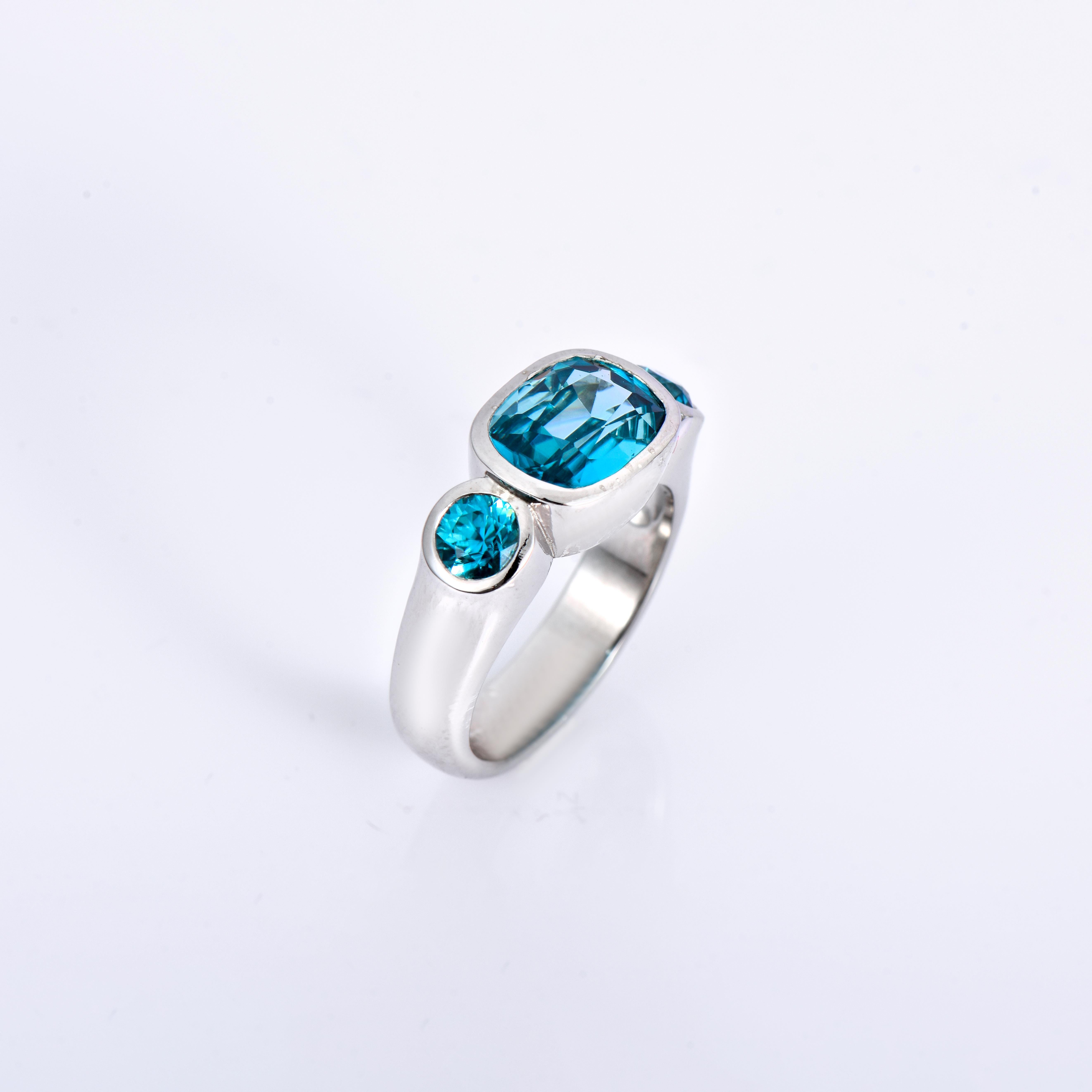 Orloff of Denmark; 925 Sterling Silver Ring set with three Natural Cambodian Blue Zircons totaling to 6.06 carats.

This piece has been meticulously hand-crafted out of 925 sterling silver.
In the center sits a 4.48 carat blue zircon mined, polished