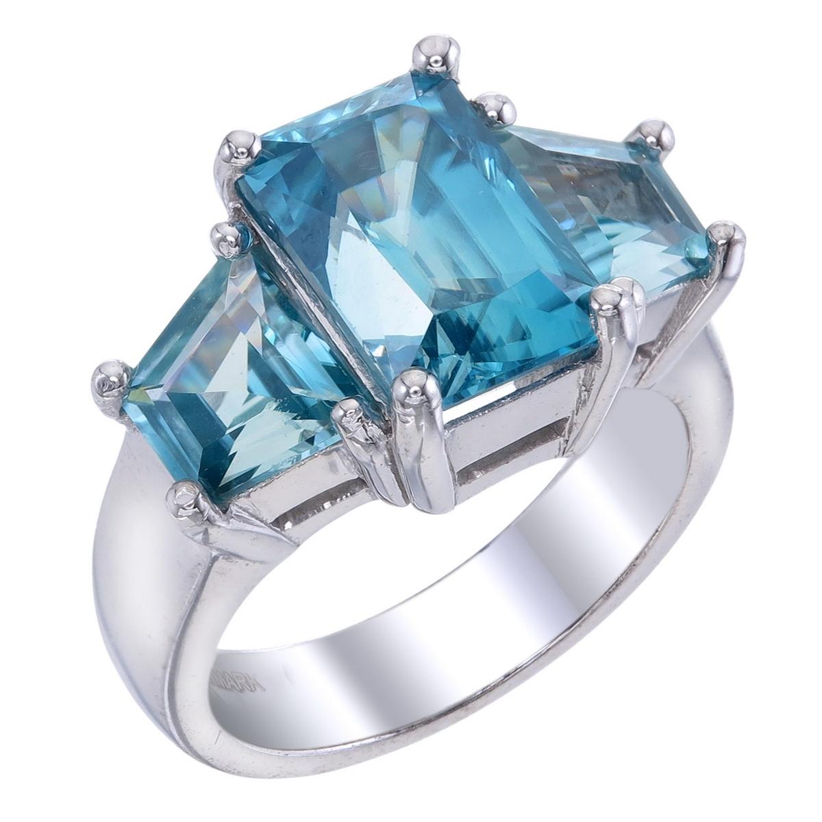 Orloff of Denmark; Natural Ocean Blue Zircon, Three-Stone ring set in 925 Sterling Silver.

Featured on this piece are three natural Cambodian blue zircons.
Occupying center-stage is a 6.76 carat ocean blue zircon full of shine and sparkle.
Two