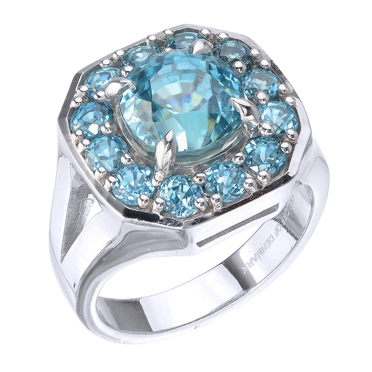 Orloff of Denmark; 925 Sterling Silver Cocktail Ring set with thirteen Natural Cambodian Blue Zircons totaling to 9.4 carats.

This piece has been meticulously hand-crafted out of 925 sterling silver.
In the center sits a 6.55 carat blue zircon