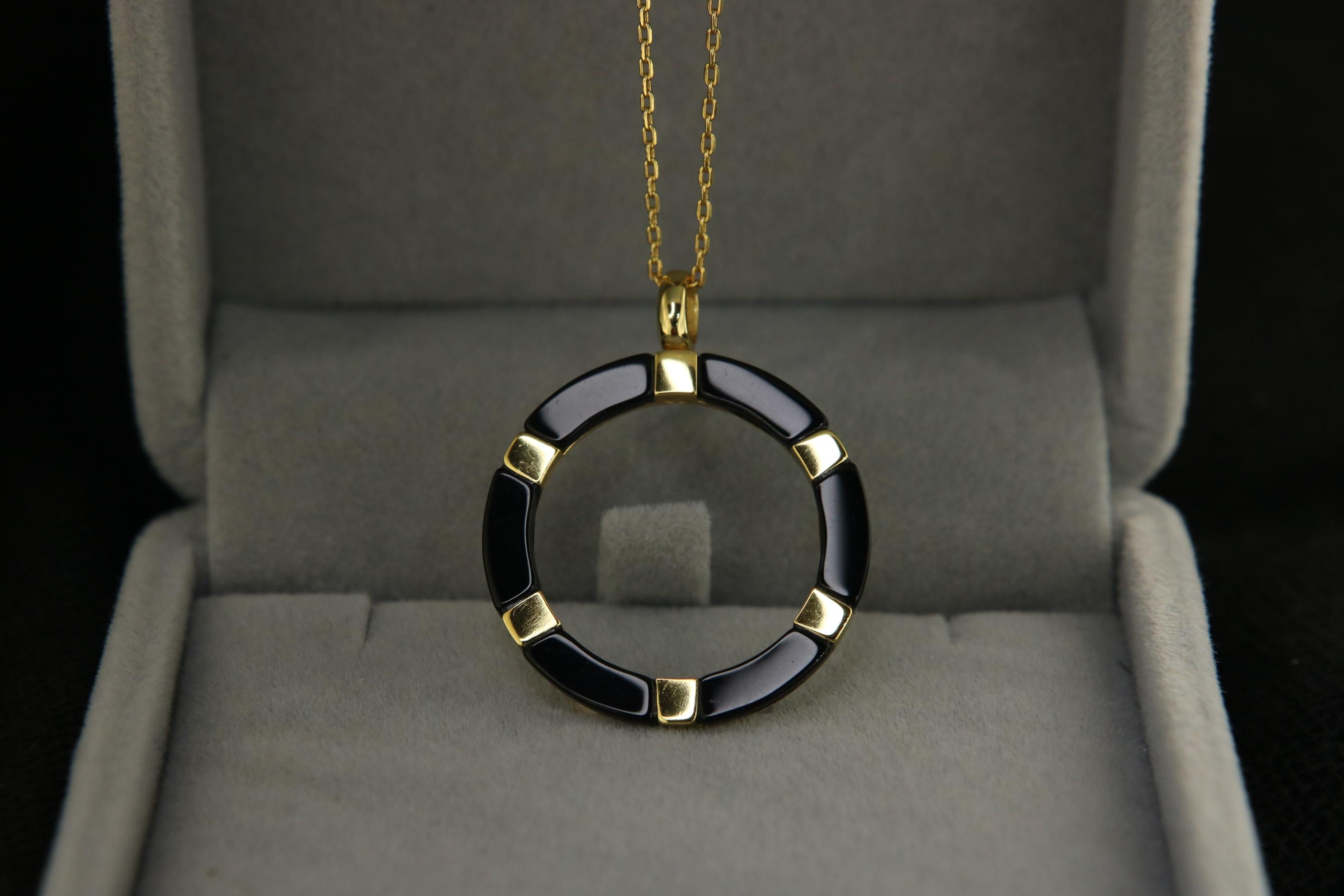 Orloff of Denmark's Aura Ringlet.

Elevate your jewelry collection with this stunning Sterling Silver Necklace, intricately designed with black enamel for a touch of modern sophistication. The pendant features a unique circular motif, alternating