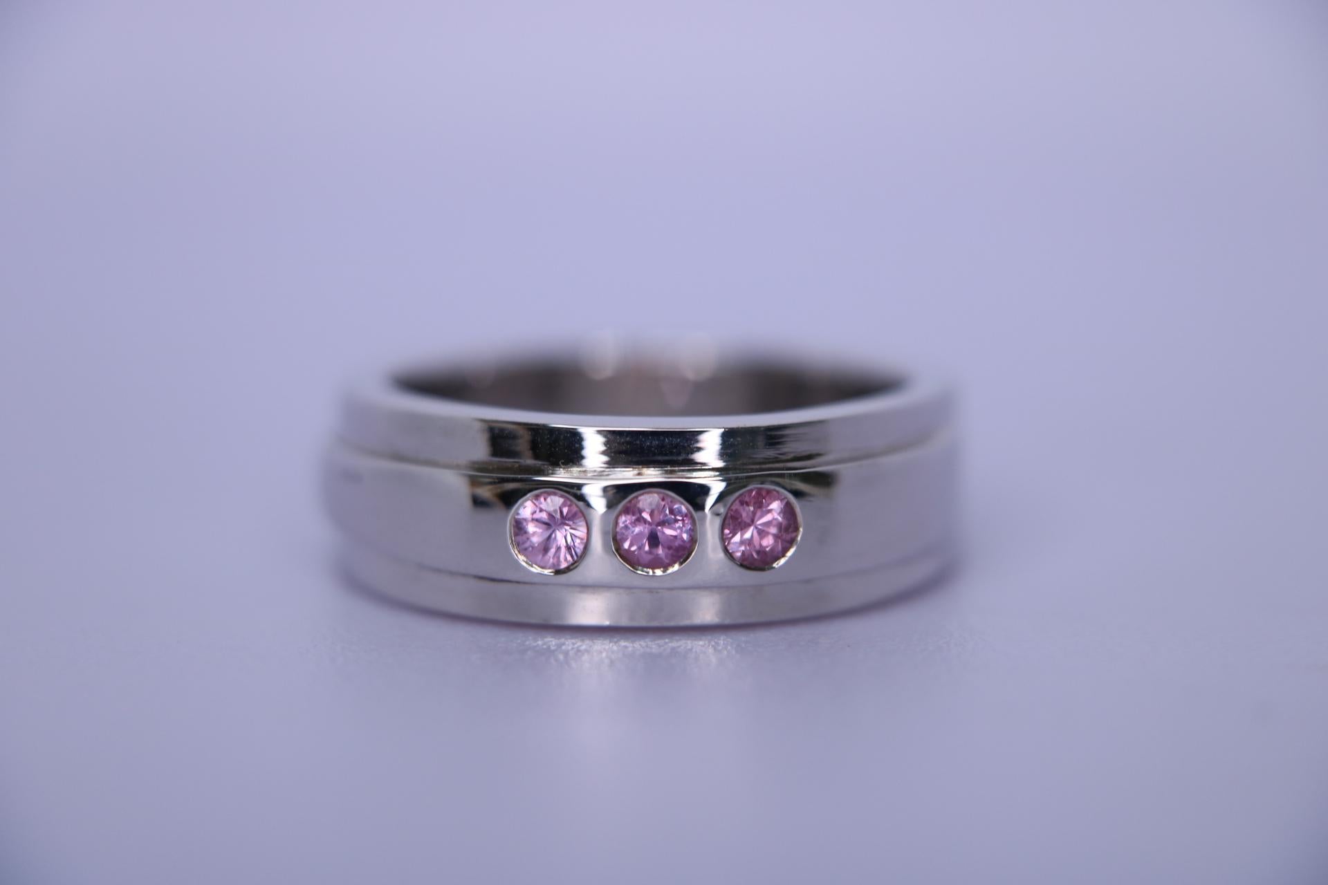 Orloff of Denmark; Fancy Pink Sapphire ring fashioned out of 925 Sterling Silver.

This handmade sterling silver ring features a trio of 2.8mm pink sapphires, delicately set to add a touch of color. The craftsmanship reflects a personal touch, with