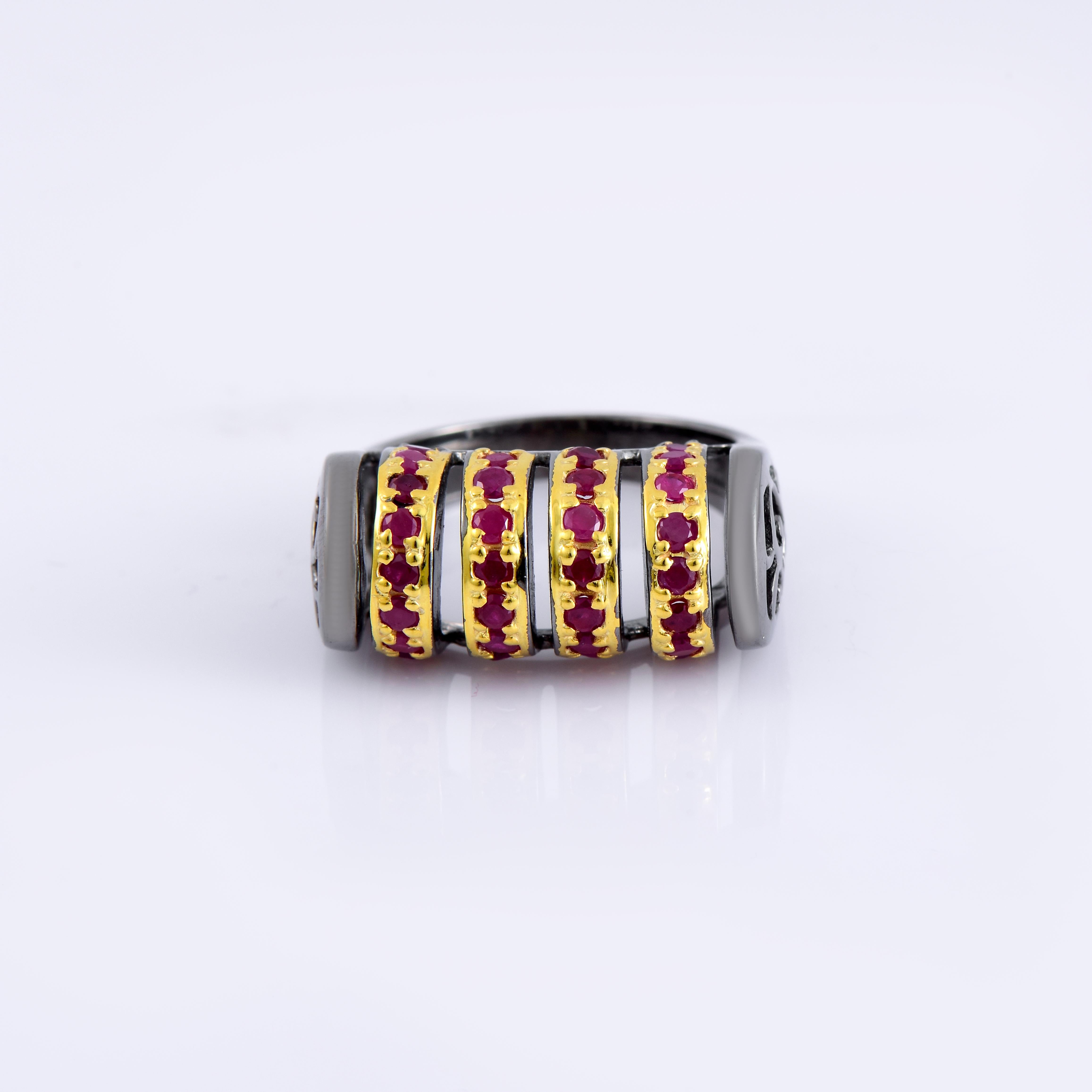 Orloff of Denmark; Ruby ring fashioned out of 925 Sterling Silver, plated with Black Rhodium and 18 Karat Gold.

This black-plated sterling silver ring is adorned with thirty-two delicate rubies, each measuring 2.6 mm in diameter. The rubies are